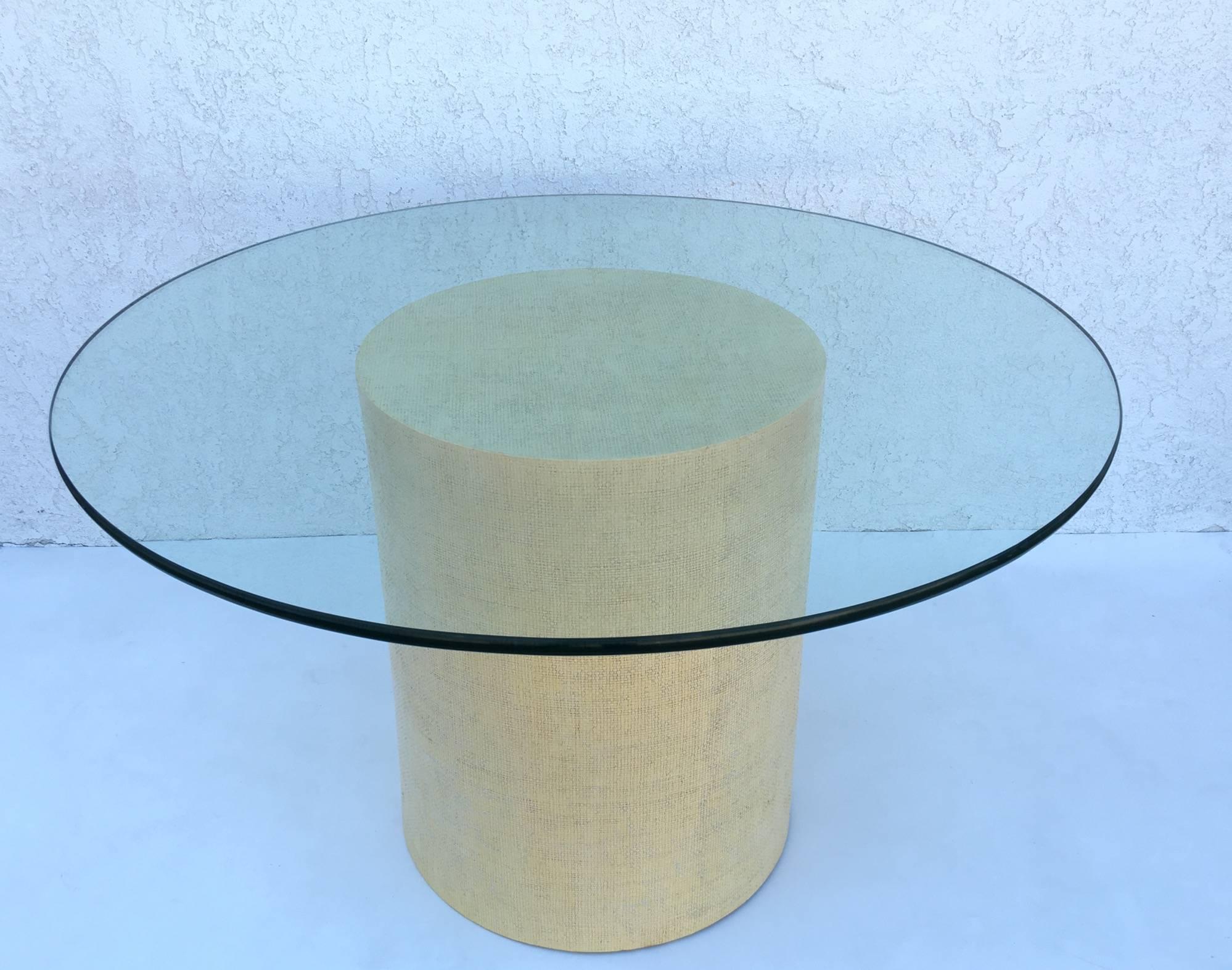 1980s dining table by Steve Chase. The base is raped with grasscloth and then lacquered in a cream color. The top is a 48