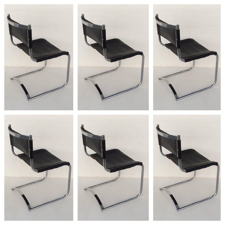 Rare set of six polished chrome and black saddle leather dining chairs attributed to CY Mann. According to the person that we purchased this from, they were originally purchased from The CY Mann Showroom in NYC in the 1970s. This are in original