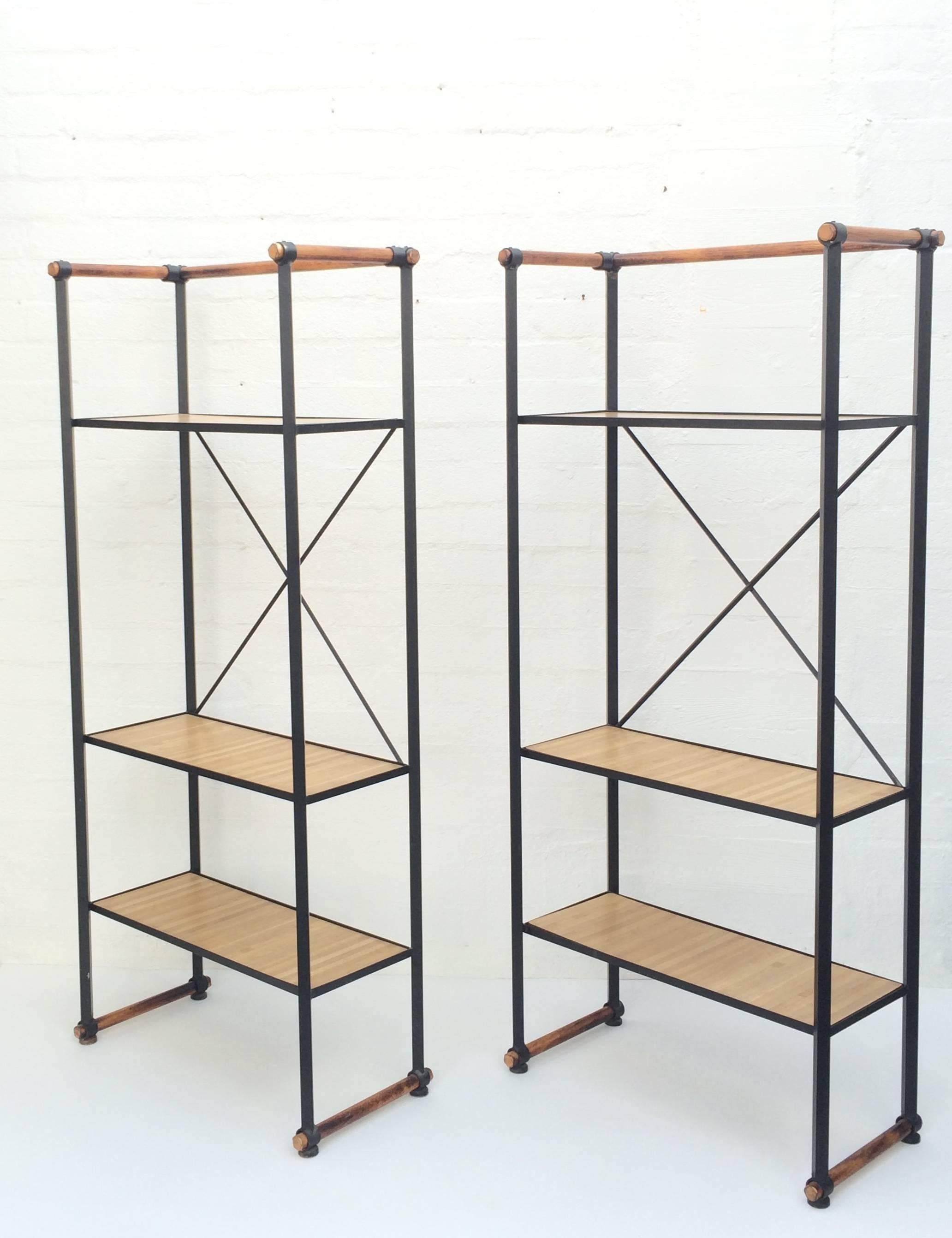 For your consideration a pair of rare Etageres designed by Cleo Baldon. 
These freestanding shelfs consist of a wrought iron stand with Cleo's signature oak wood accents at the top and bottom. 
Each stand has the original three removable inset