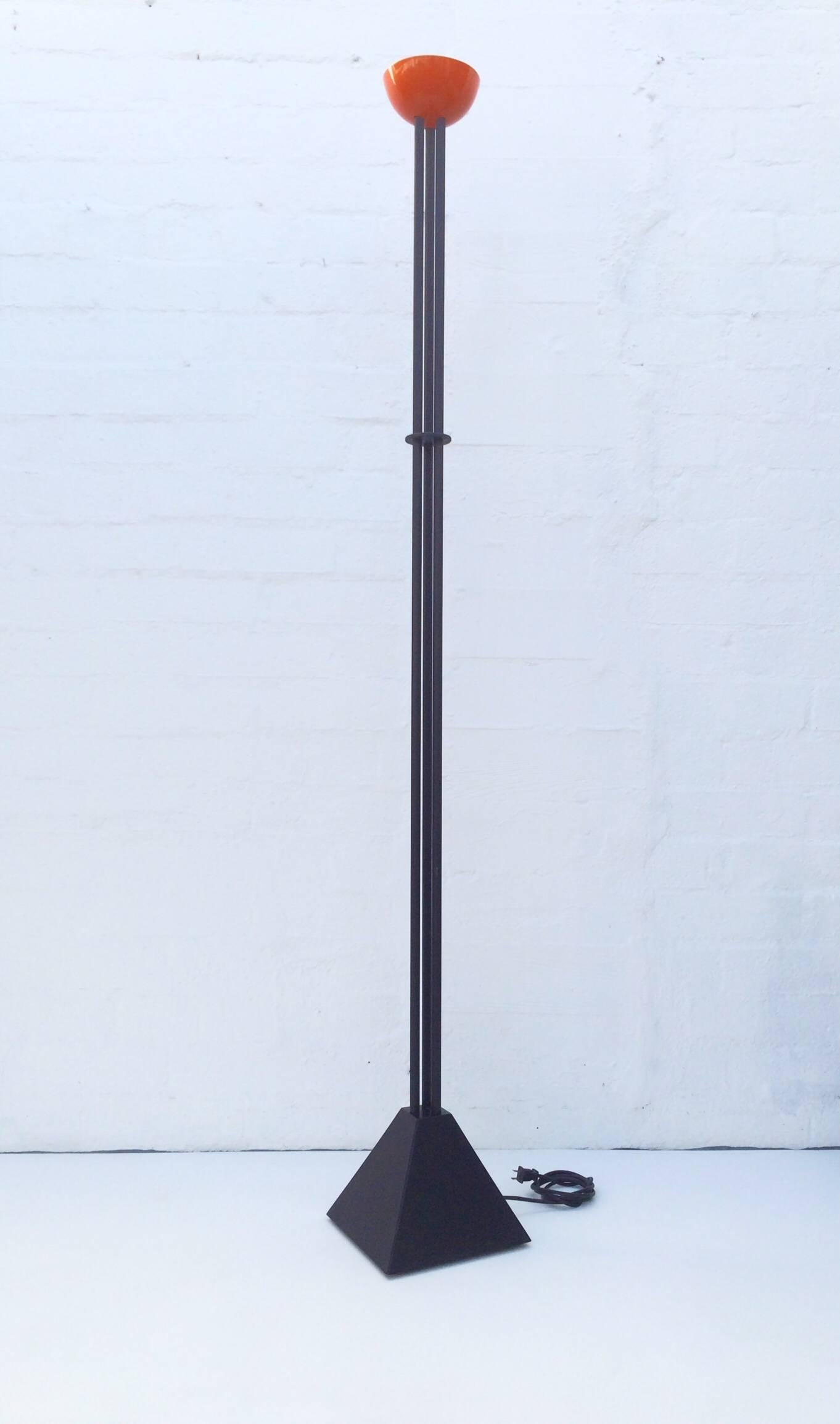 Torchiere floor lamp designed by Ron Rezek, circa 1980s. 
Orange enamel top with black powder-coated steel base. 
This lamp takes a small halogen bulb and has a dimmer that works by touch.
    