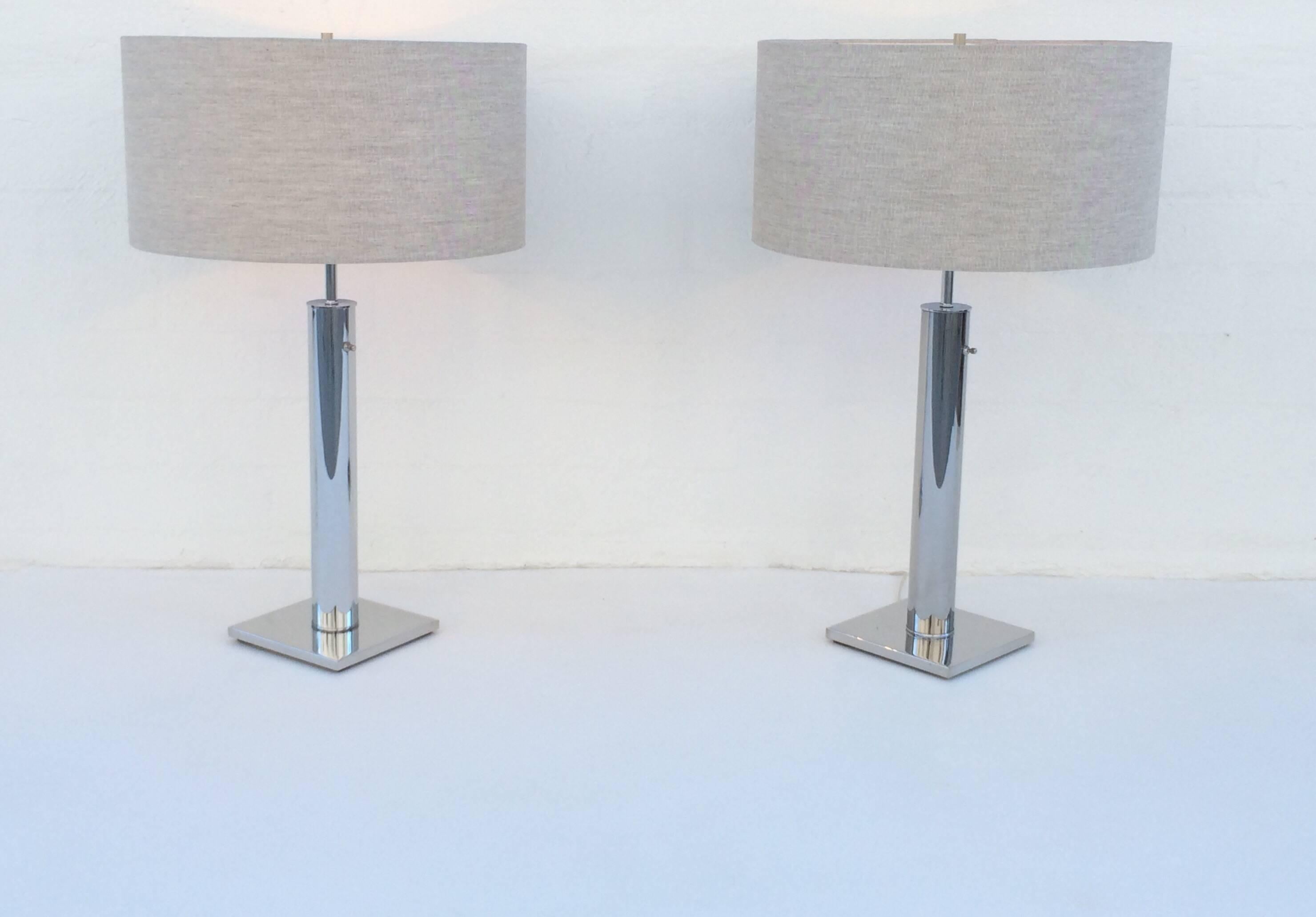 Pair of newly re-plated polished chrome 1960s table lamps by Nessen. 
Newly rewired with new oatmeal colored shades. 

Lamps are 32