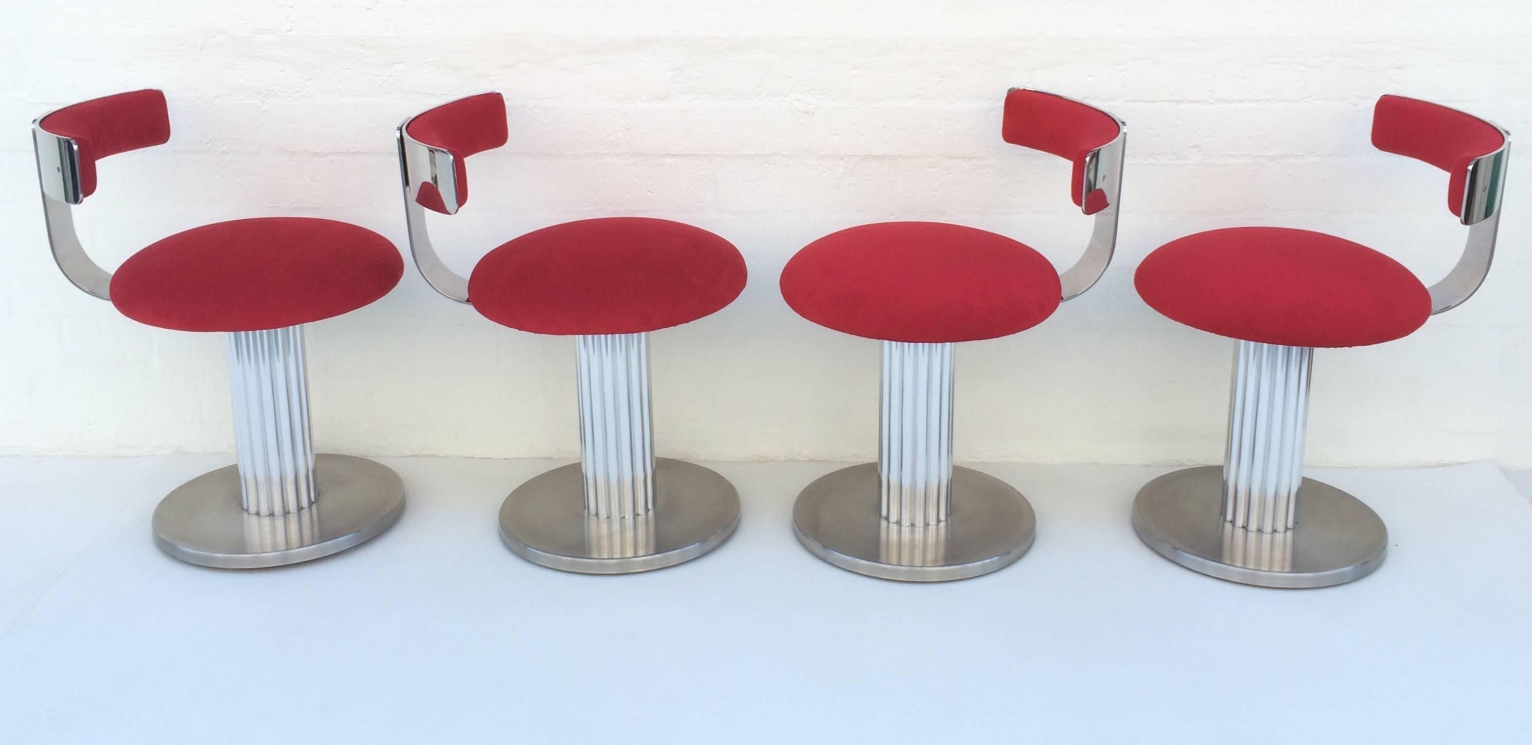 These swivel stools are made of mixed metals with the base being brushed stainless steel and polished aluminum.
The backrest is polished stainless steel.
Upholster in a red ultra-suede.