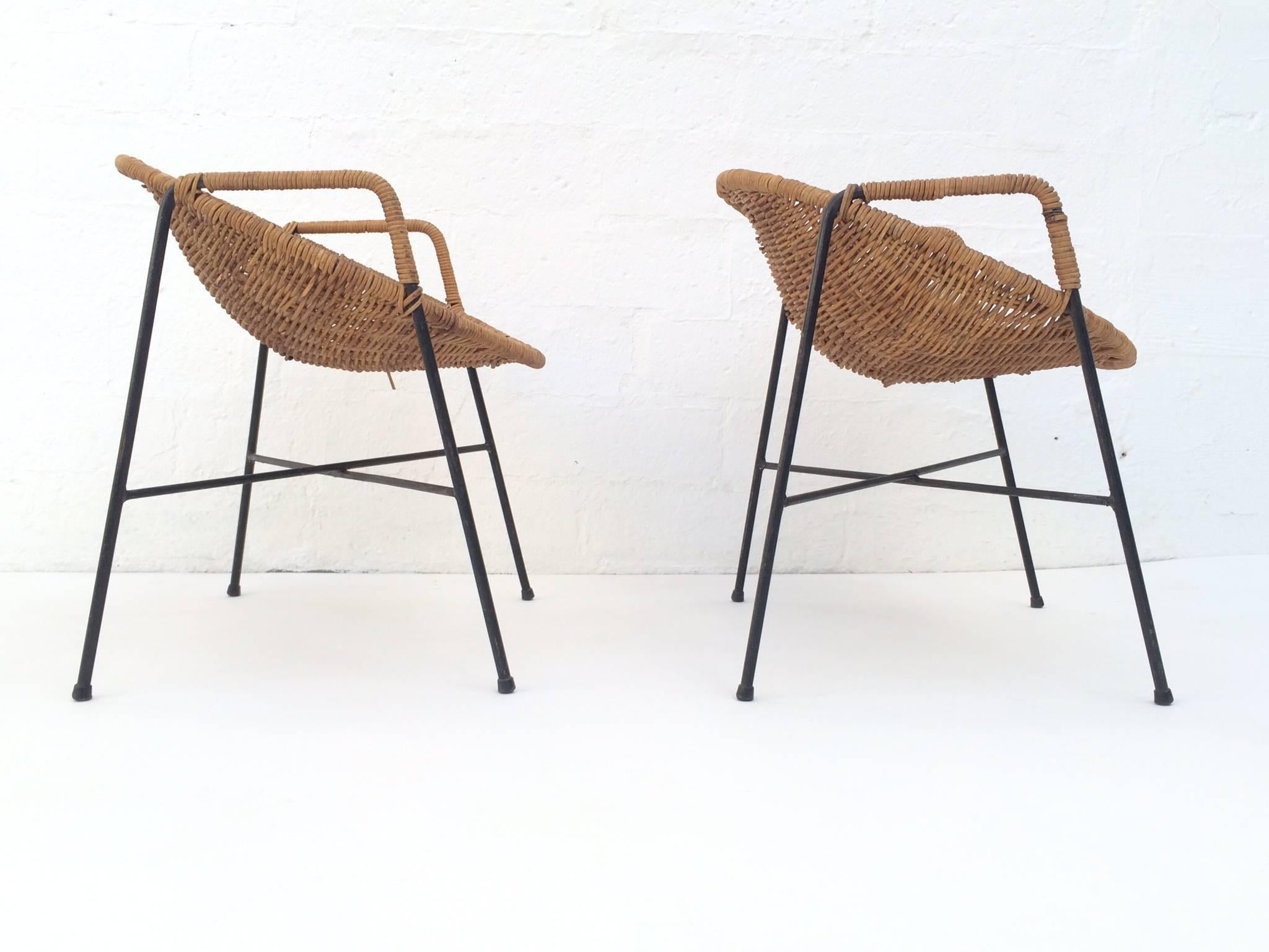 A pair of fun child chairs by Salterini.
These rare chairs are black wrought iron and wicker.
Excellent condition with very little ware consistent with age and use.
    