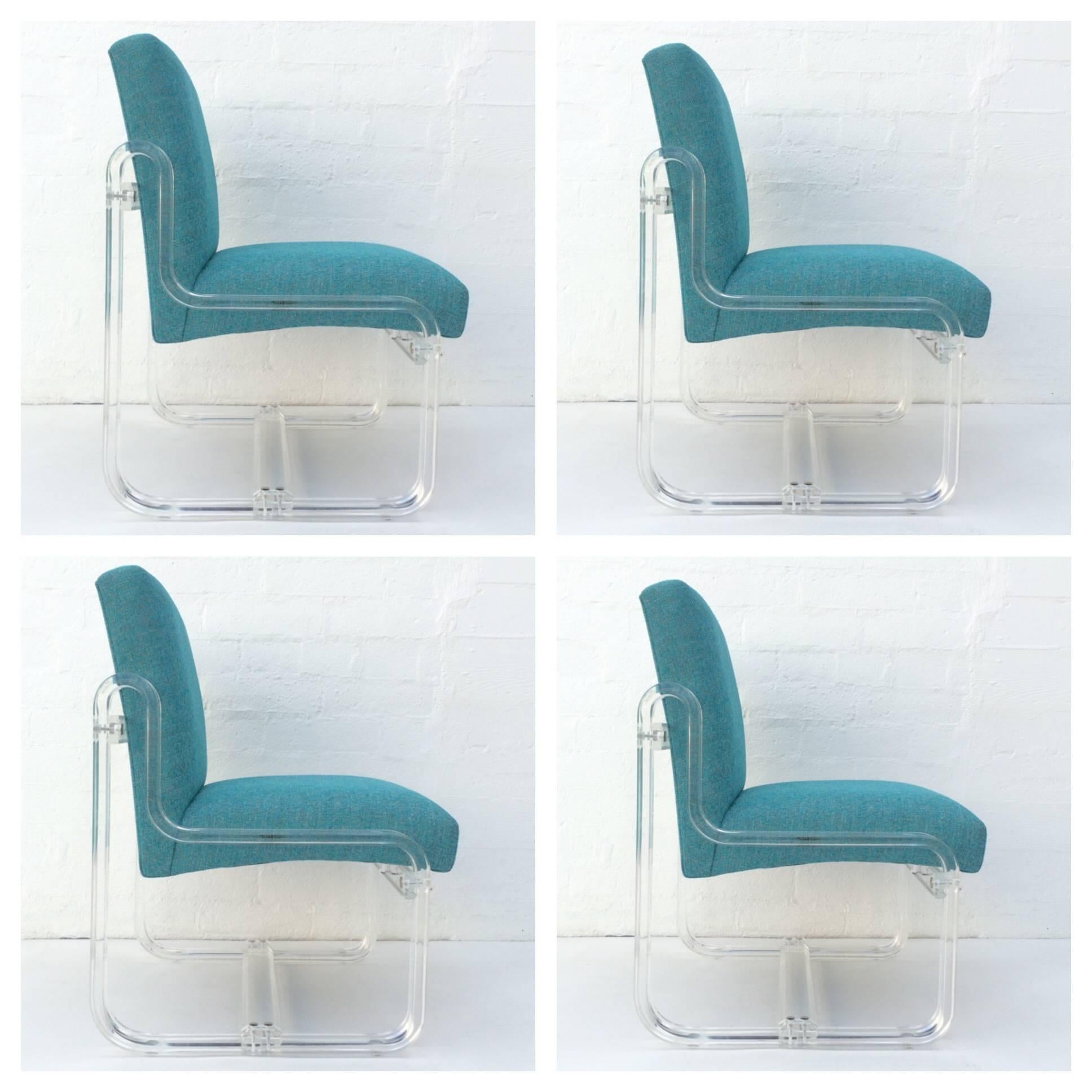 Set of four newly reupholstered in an aqua blue fabric with slight gray tones acrylic dining chairs.
The acrylic has been professionally polished.
Made by Vivid of Los Angeles, circa 1980s.