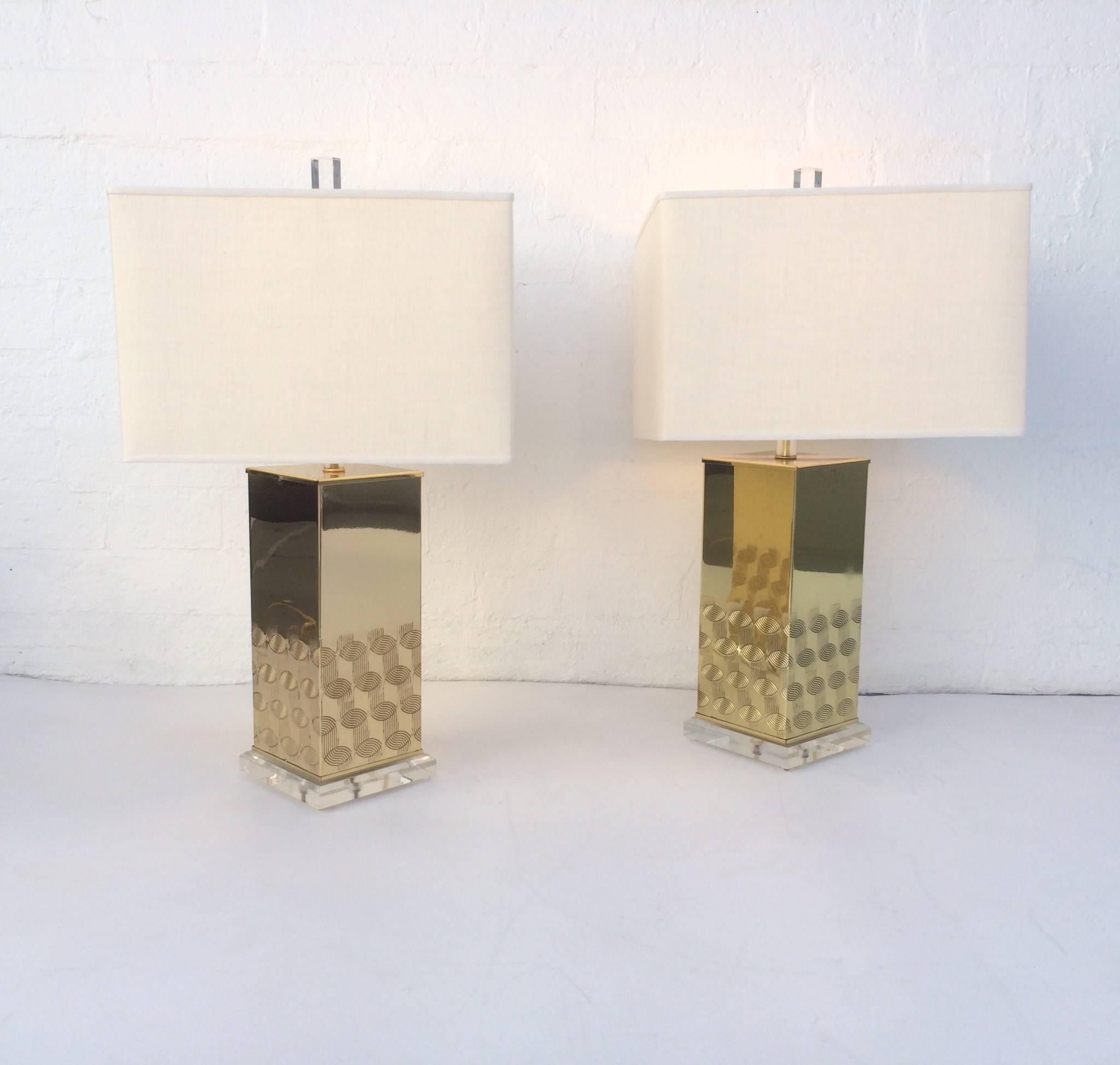 A pair of 1970s polished brass table lamps with acrylic bases and finials. All new brass hardware and newly re-wired. New vanilla linen shades.