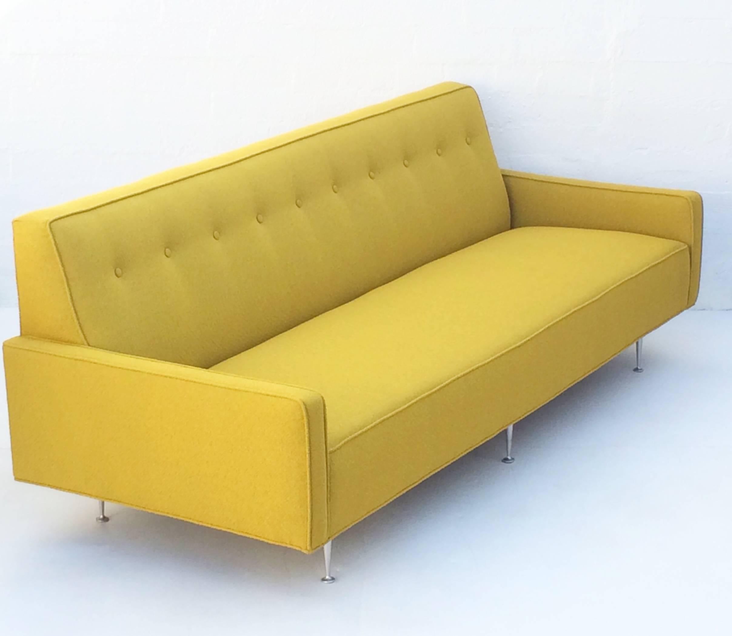 Gorgeous Thin Edge sofa designed by George Nelson and made by Herman Miller.
This early 1950s sofa has solid cast aluminum legs and is newly reupholstered in a stunning mustard color Knoll style fabric.