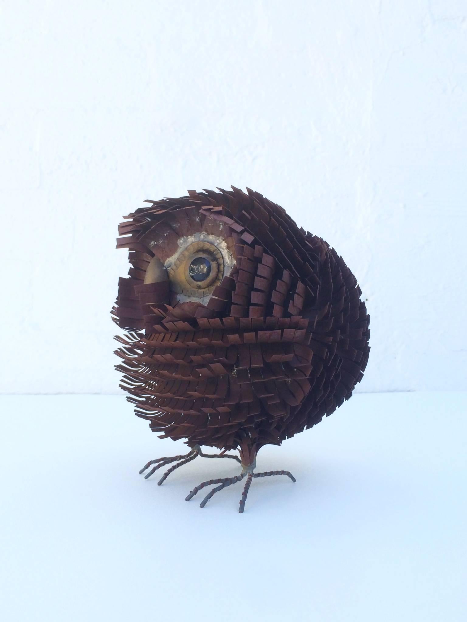 A whimsical owl sculpture made of brass and metal by Curtis Jere, circa 1970s.
      