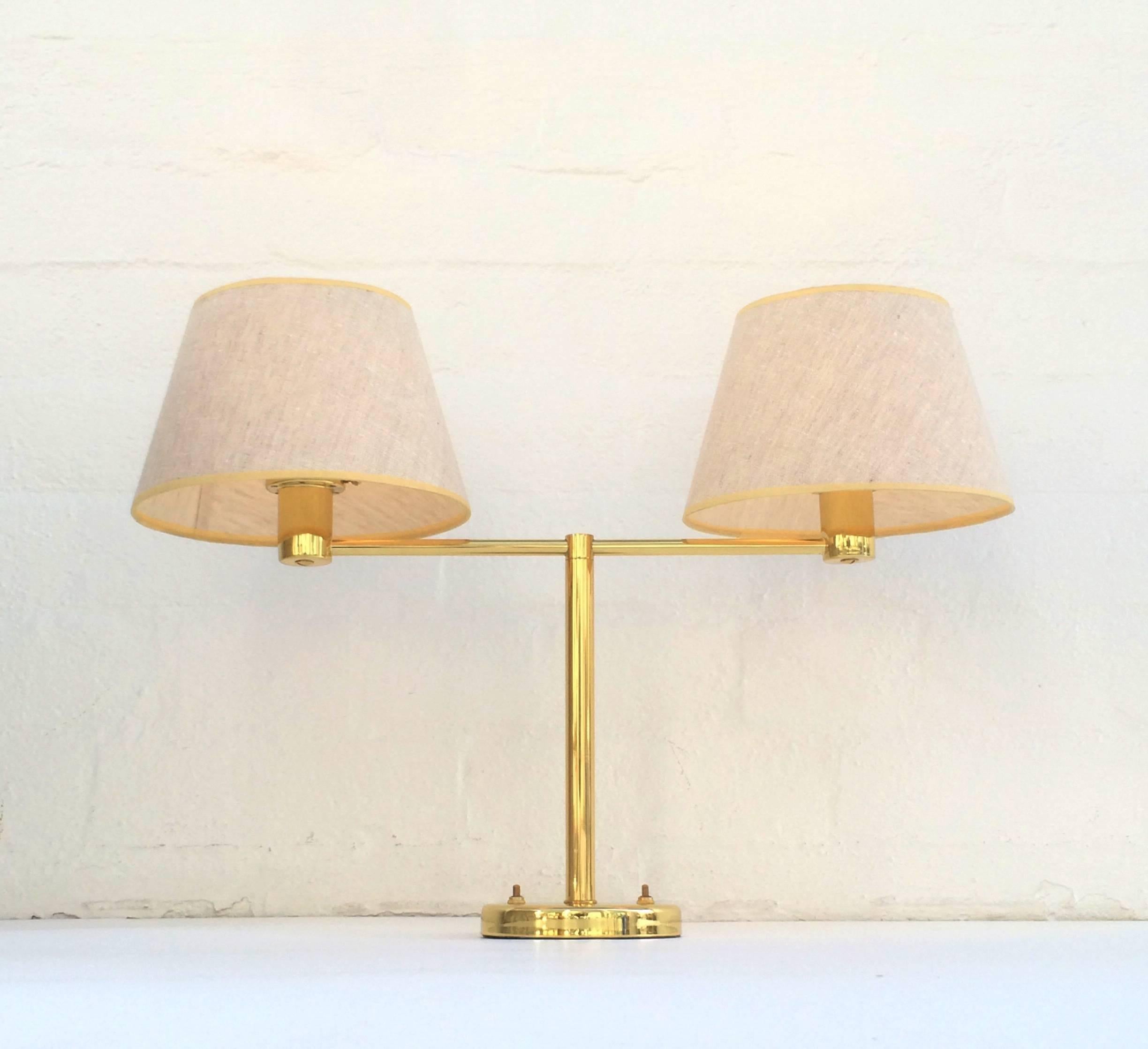 Stunning polished brass desk lamp by Nessen. 
This double shade desk lamp is newly re-wired with new oatmeal linen shades. 
Each light turns on/off independently.