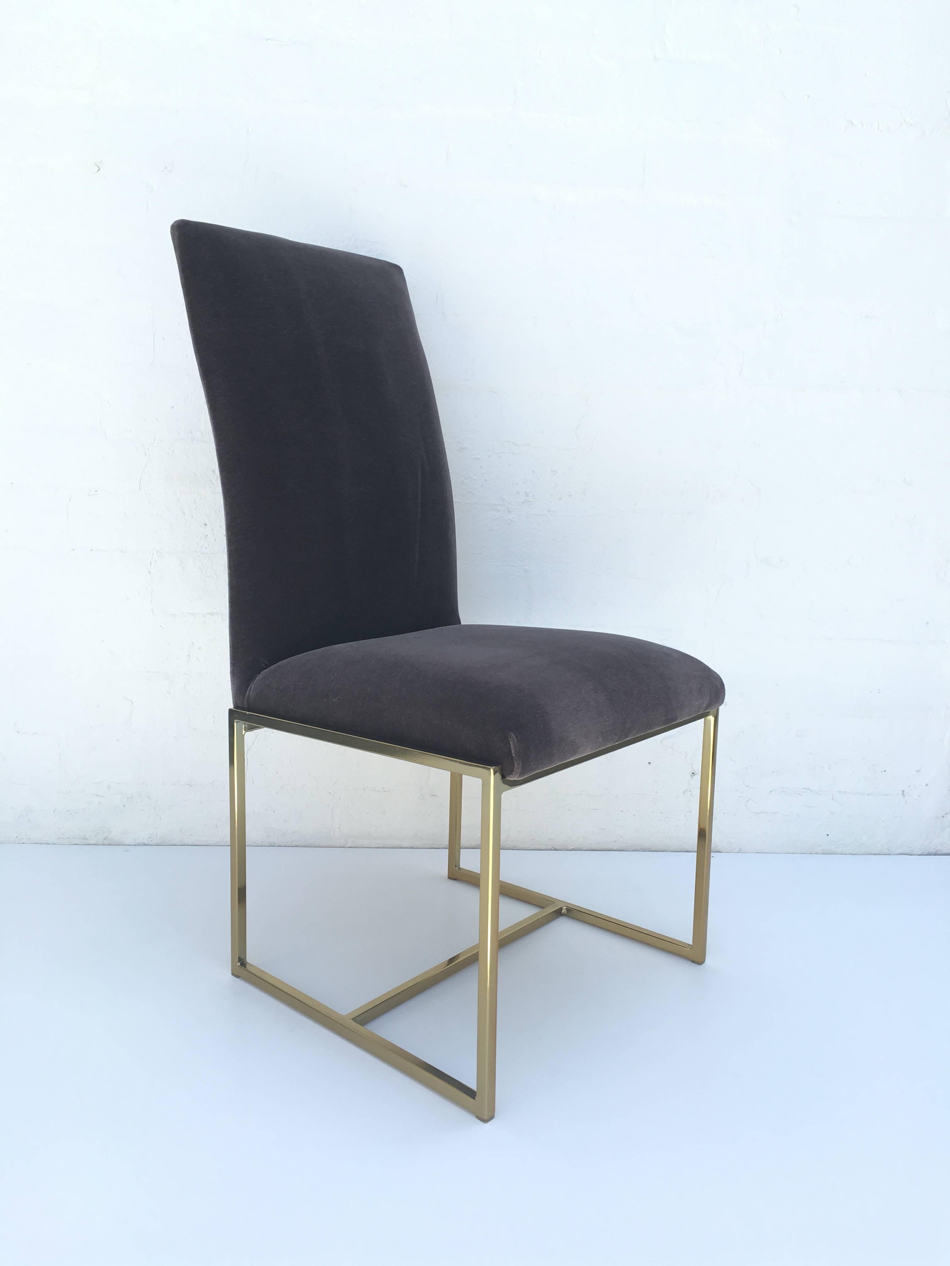 Set of six high back dining chairs designed by Milo Baughman for Thayer Coggin in the 1970s. The lower frame is polished brass. Newly reupholstered in a soft dark grey mohair.