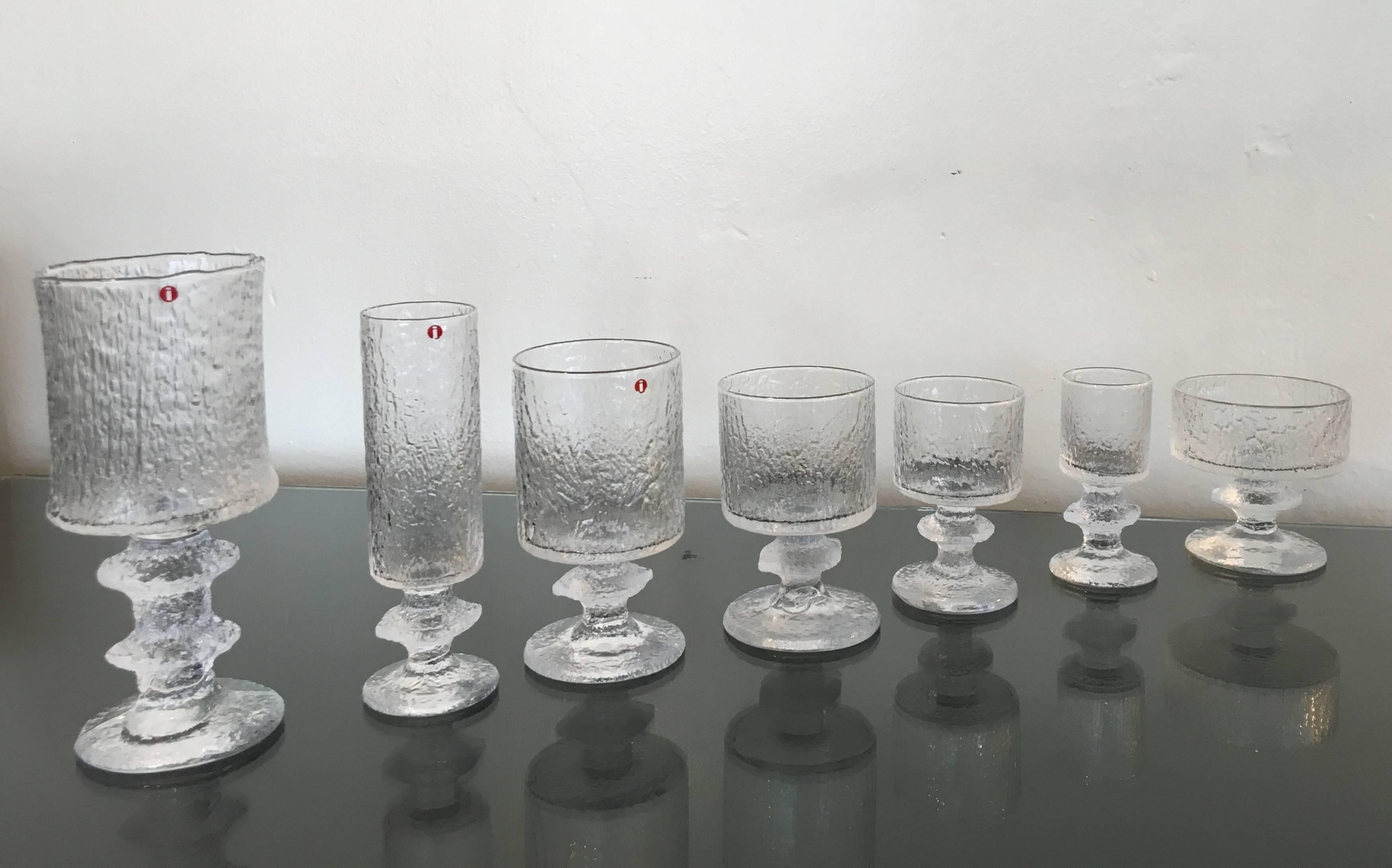 A very glamorous service for eight drink set by Timo Sarpaneva for Iittala.
It's very rare to find a hole set together like this. Most of them have Iittala tags or marked TS. 
The tallest is 7 7/8 high 3 3/8 diameter.
The smallest one is 4 3/8 high