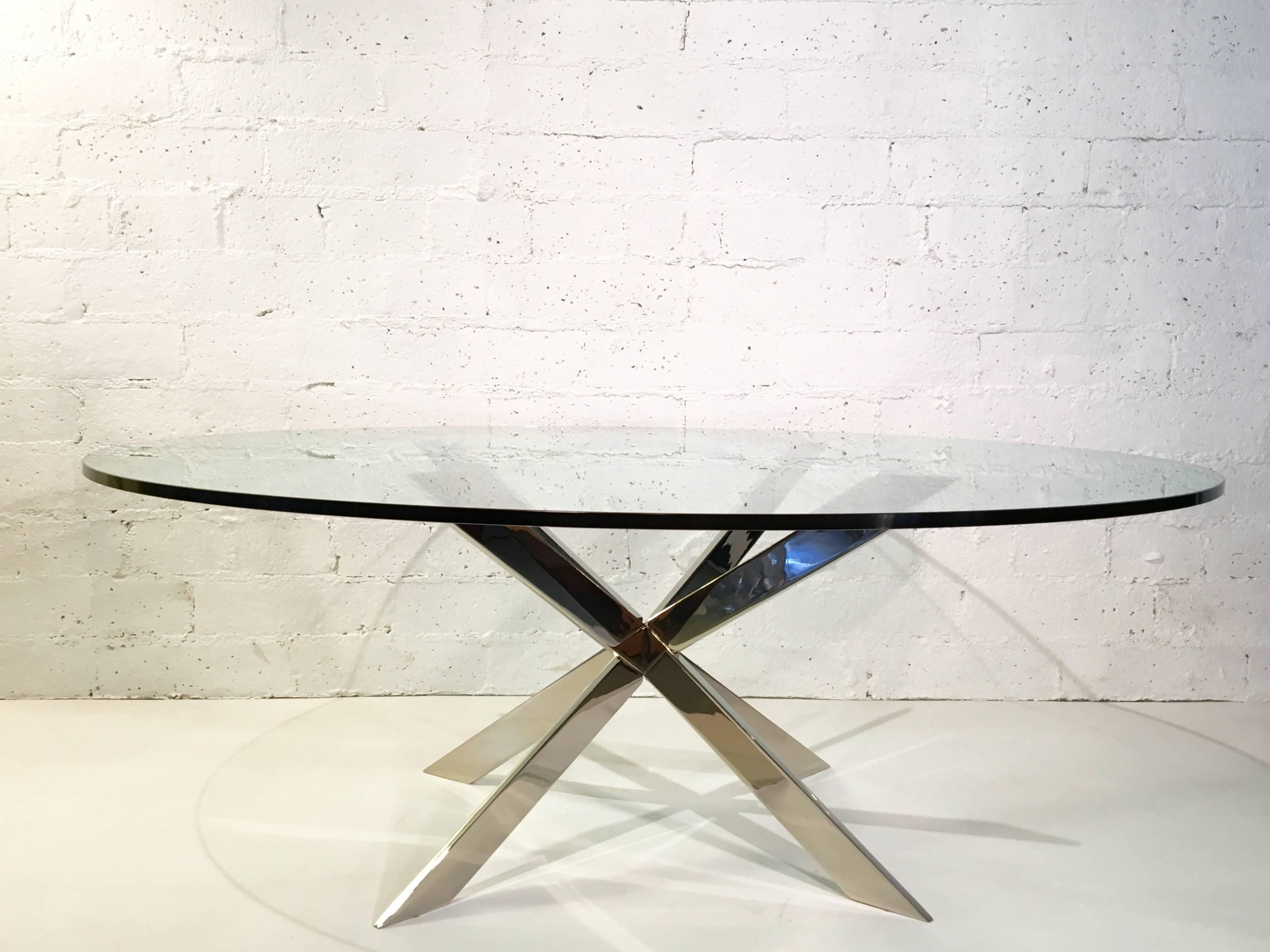 An elegant nickel X-base and glass cocktail table by Leon Rosen for Pace Collection. The base is a solid steel base, that has been newly nickel-plated and new 1/2