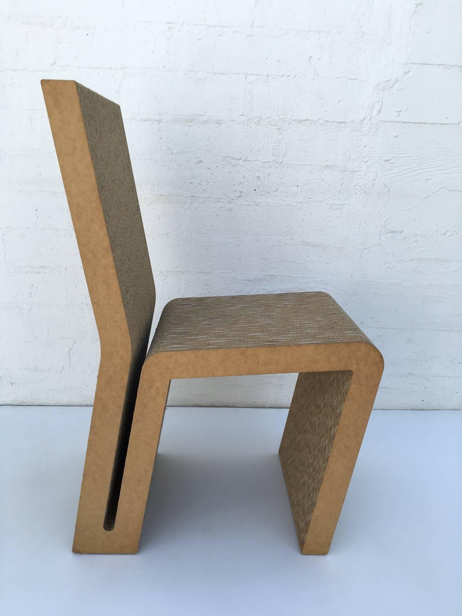 Iconic easy edges side chair. Designed by Frank Gehry for Vitra in the 1980s.
The chair is constructed of cardboard and Masonite.
The chair is in good condition with a small piece of Masonite missing down on back leg. See