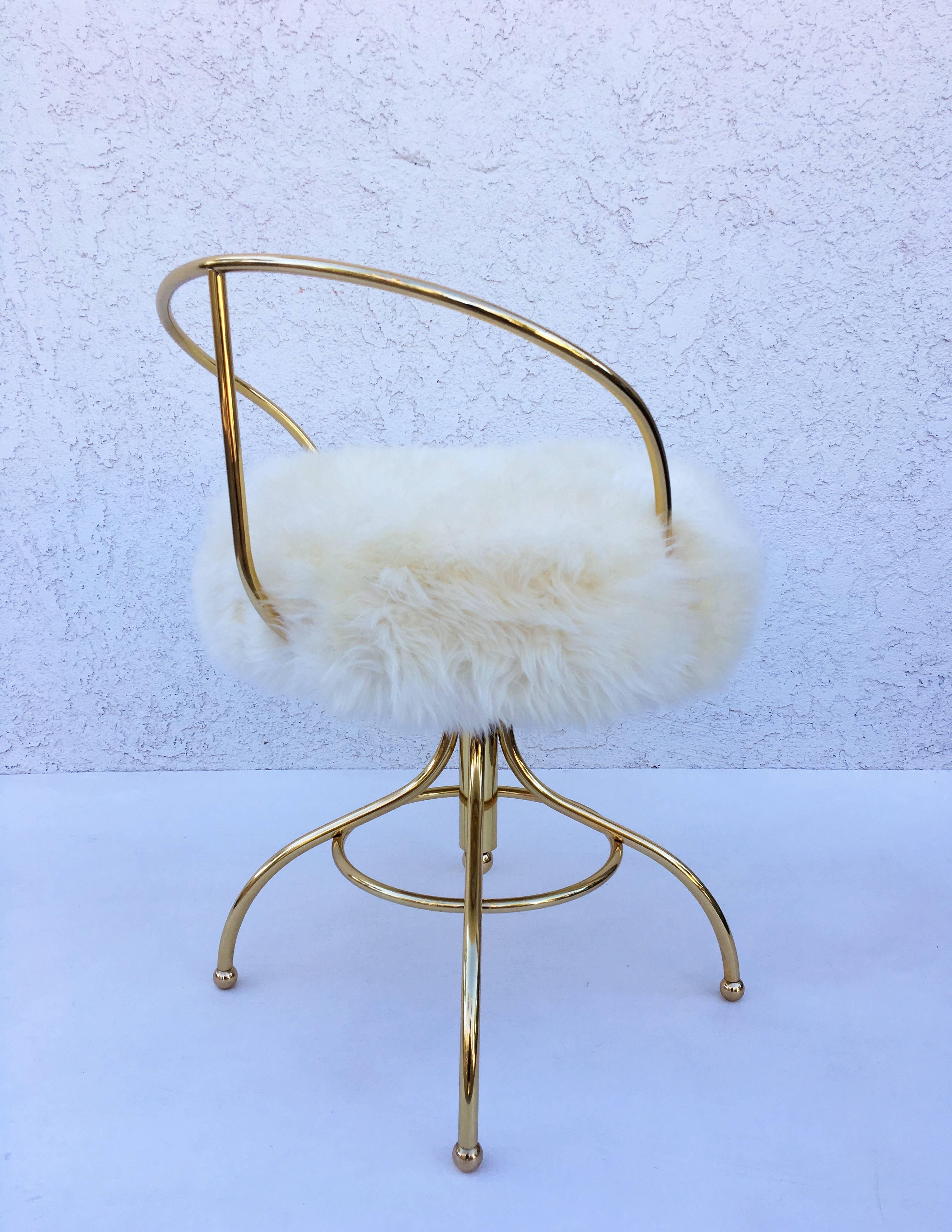 A glamorous polished brass and sheepskin swivel stool from the 