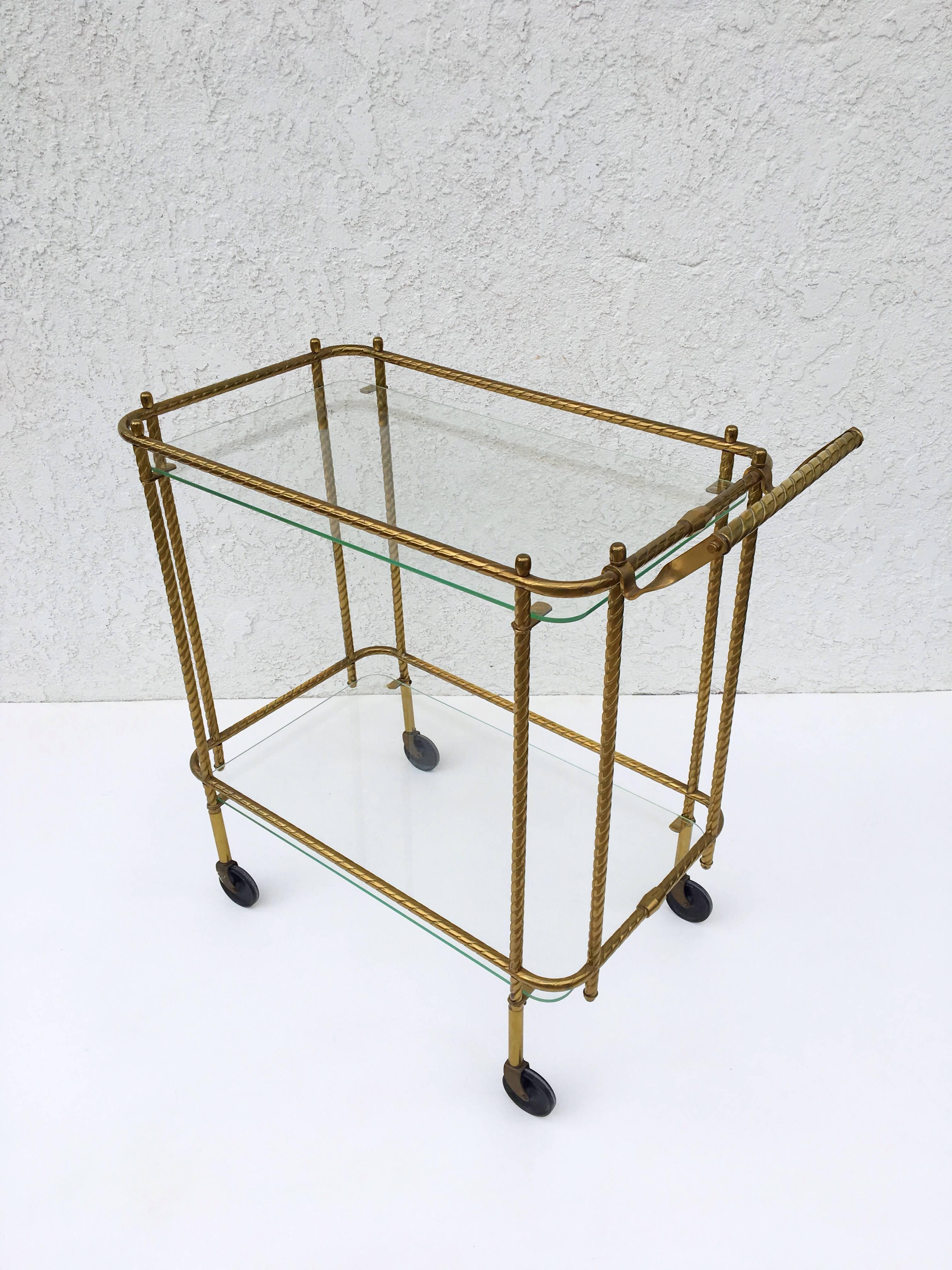 Aged brass and glass two-tier bar cart from 1970s.
The glass is 1/4