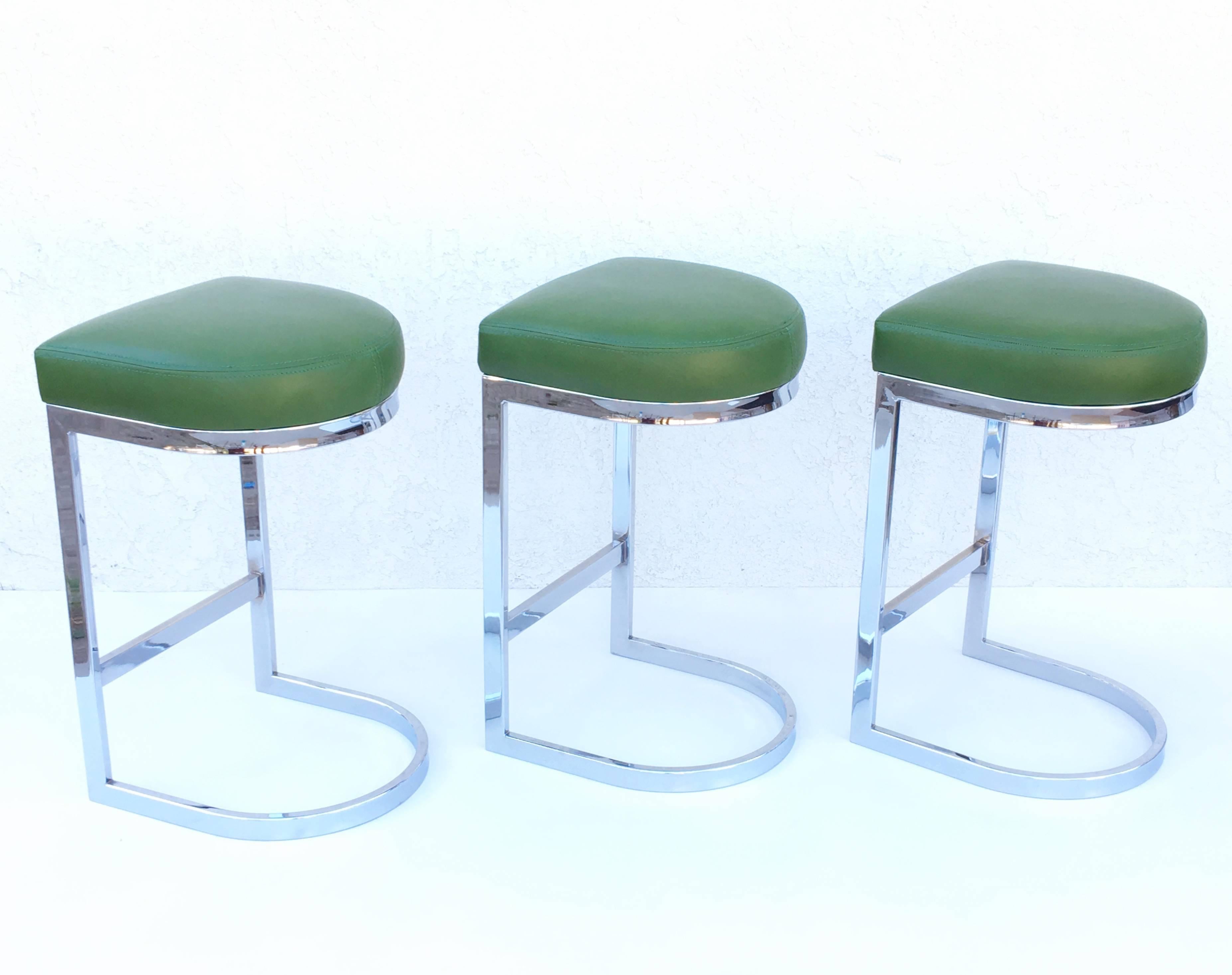 Set of three chrome and forest green leather design by Milo Baughman in the 1960s.
Newly reupholstered in a soft forest green leather.
Minor wear on the foot rest.
 