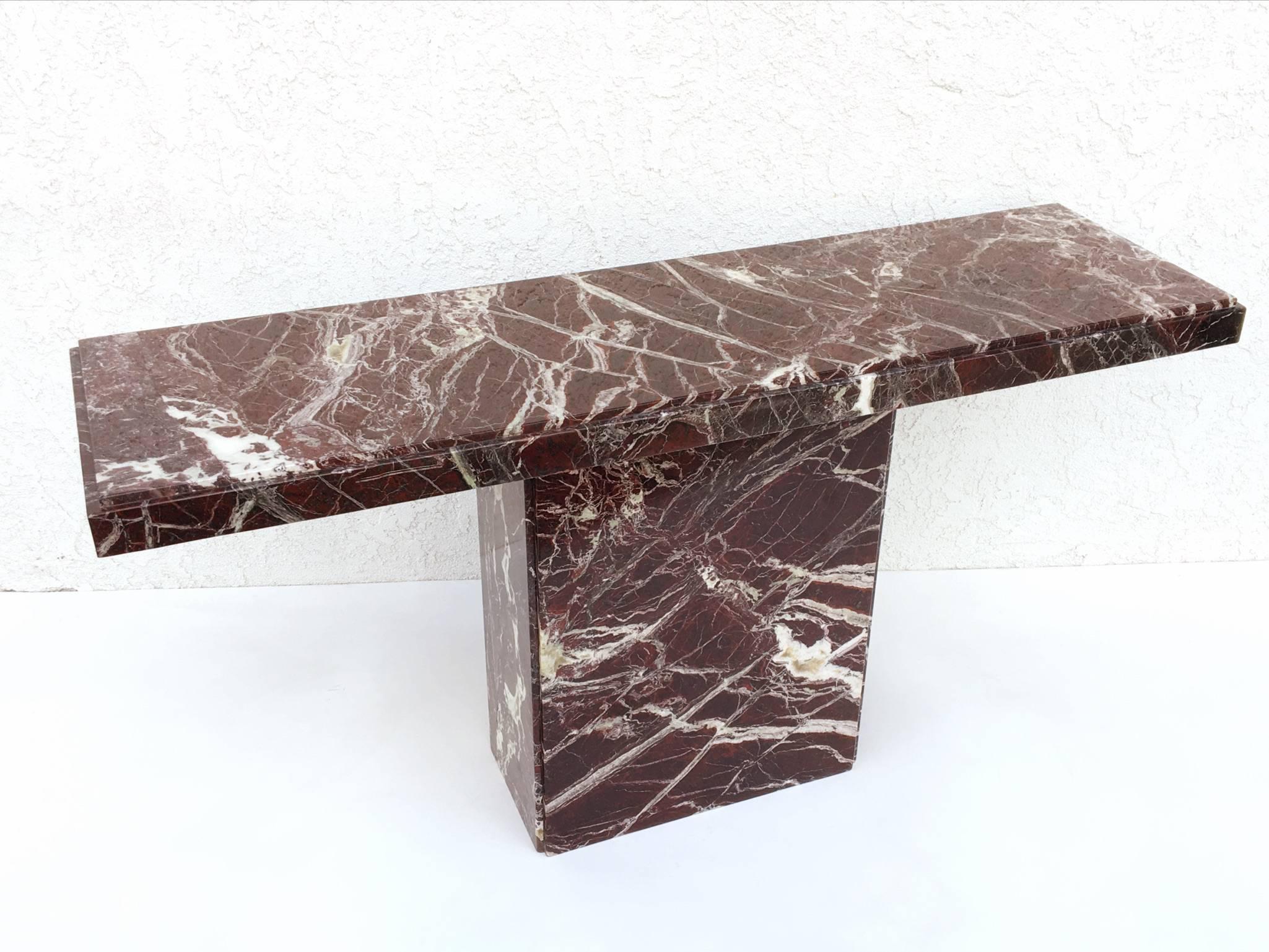 A 1970s beautiful all marble console table. The marble is a dark burgundy color with some gray tonesnice. It does have beautiful patern veins with some quartz. It was professionally repaired and polished. Please see detail photos.

Dimensions: 28