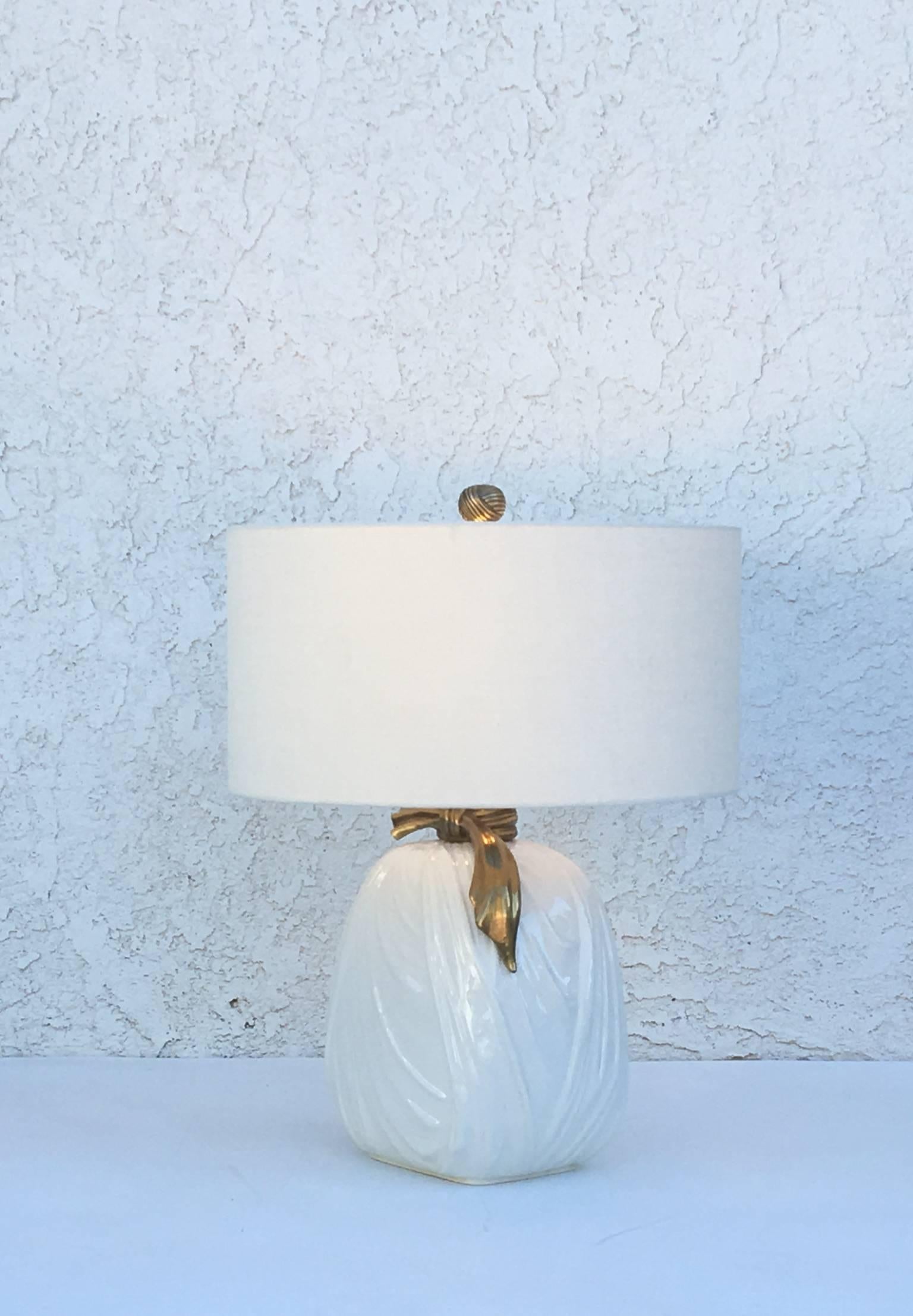 Pair of 1982 glazed ceramic and brass table lamps by Chapman. 
Newly rewired and new vanilla linen shades. 
The lamps have original finials. One of the lamps have small dent on glazed see detail photos. 

Overall dimensions 20