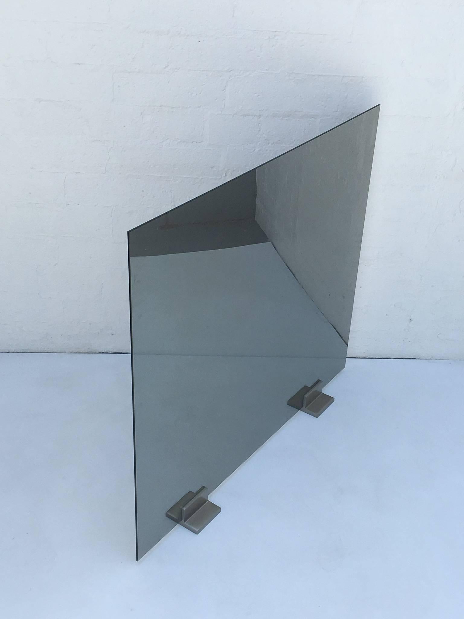 Les is more with this elegant mirror smoked glass with brushed stainless steel feet fireplace screen by Pace Collection from the 1980s.
One side is mirrored but you can see the fire when on.

Diameter: 40