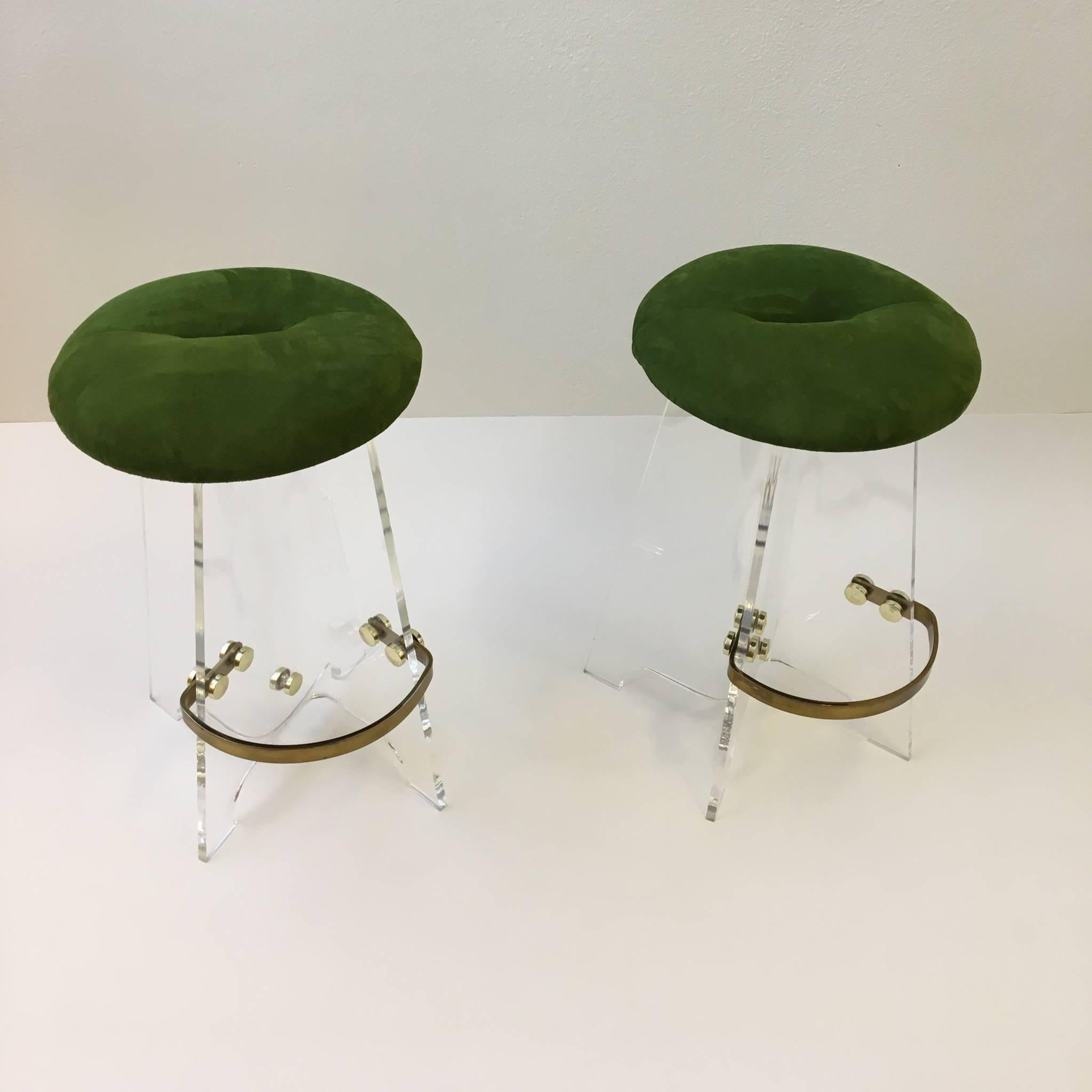 Beautiful pair of Acrylic and suede leather with aged brass footrest. 
Newly reupholstered seats in a olive green suede leather. 
Dimensions: 28.5