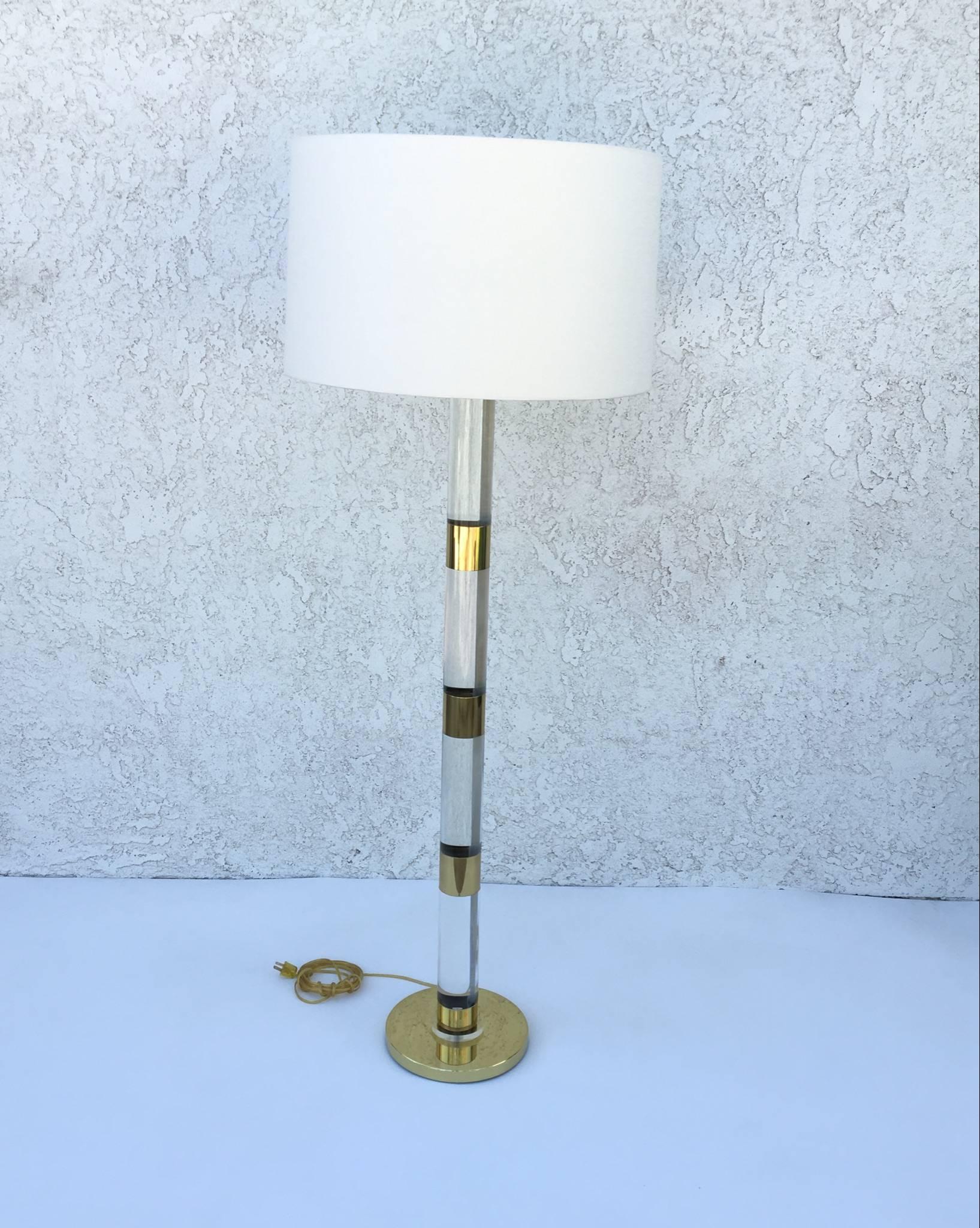 A large glamorous acrylic and polished brass floor lamp designed by Frederick Cooper in the 1970s. 
The lamp has been newly rewired and new vanilla linen shade. 
The bottom base has minor little dents see detail photos. 

Dimensions: 64