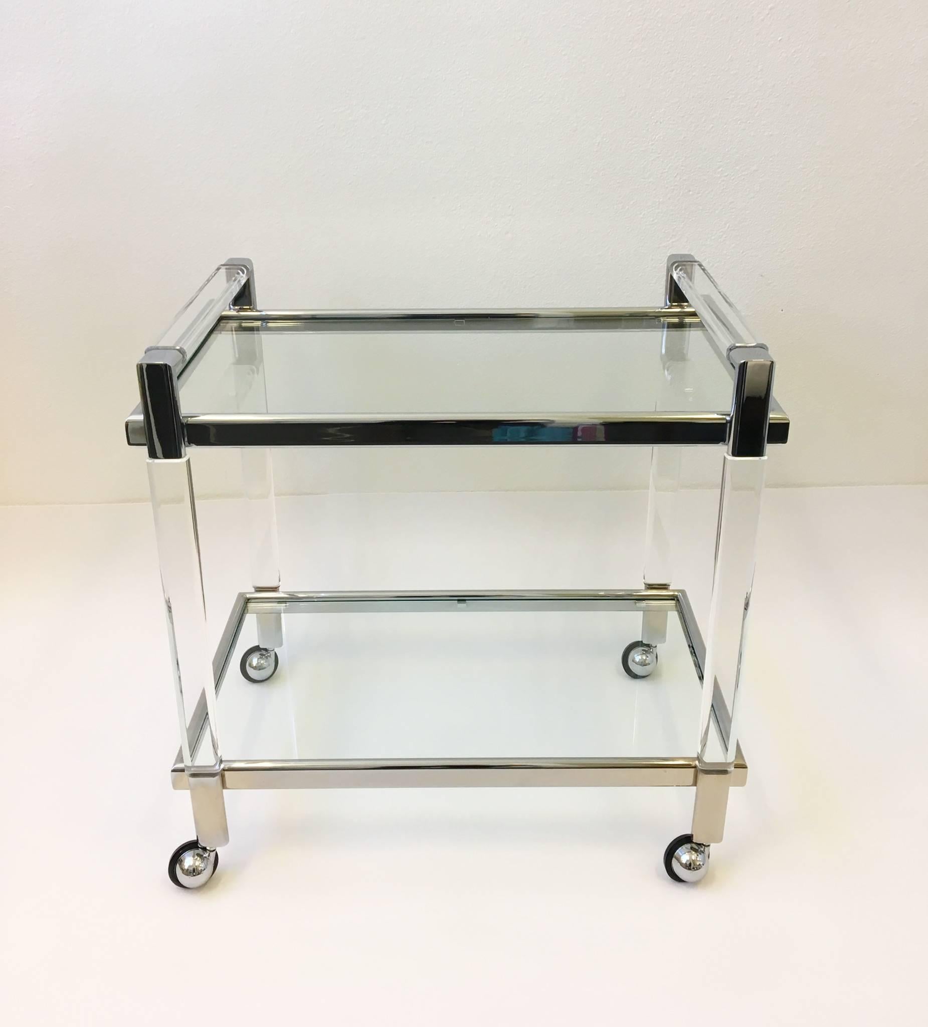 A glamorous acrylic and chrome with glass inserts bar cart design by Charles Hollis Jones in the 1970s. It's signed by Charles Hollis Jones and we replaced the glass inserts. 

Dimensions: 32
