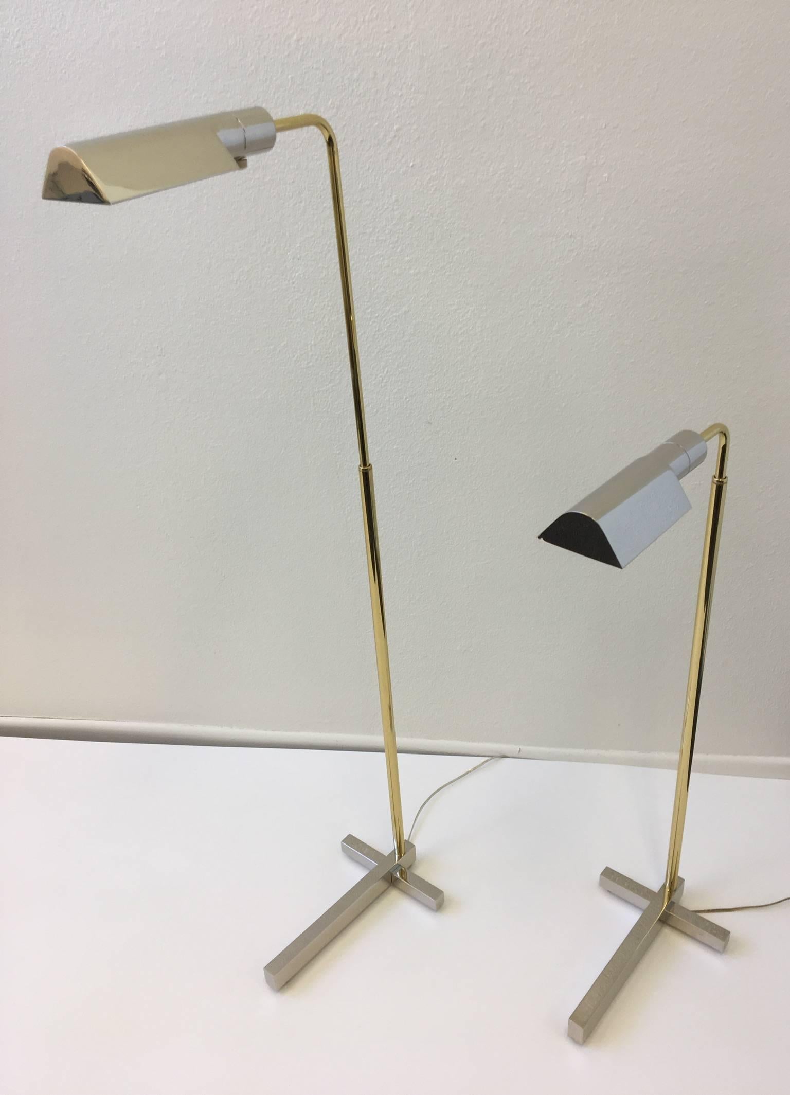 A pair of two tone adjustable floor lamps by Casella.
The lamps have been newly replanted, the base and shade part are polished nickel and the adjustable pole is polished brass.
The lamps have been newly rewired with sockets that are