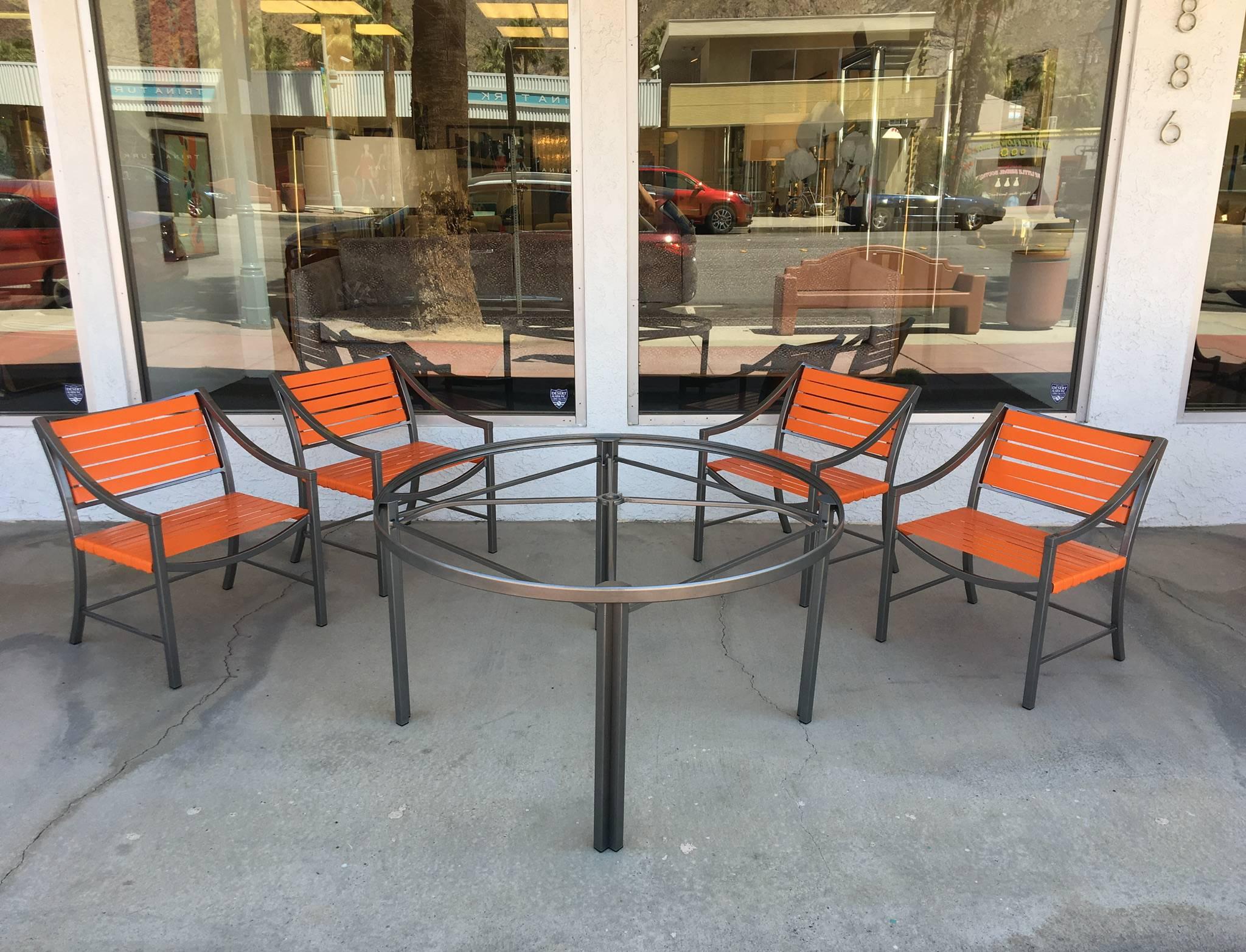 A beautiful 1970s dining set by Brown Jordan.
All newly professionally restored in a charcoal grey and tangerine orange strapping. 

Dimensions: 
Chair: 28.75 high, 22.25 wide, 22" deep, 15.25 seat. 
Table: 26.25" high, 47.5"