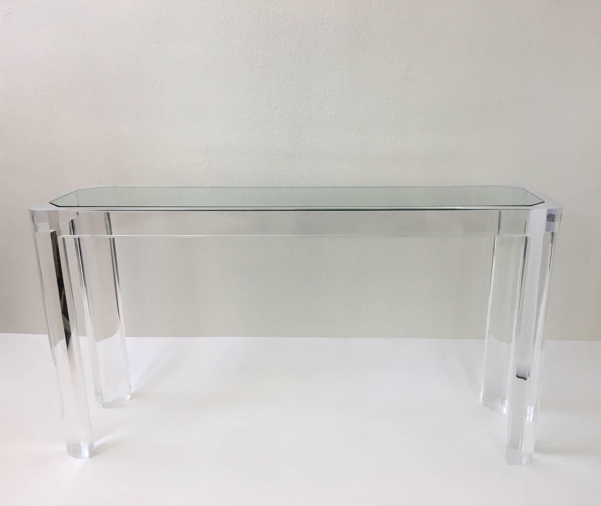 An amazing clear acrylic and glass console table by Les Prismatiques.
The table is constructed of thick clear acrylic with a 1/2