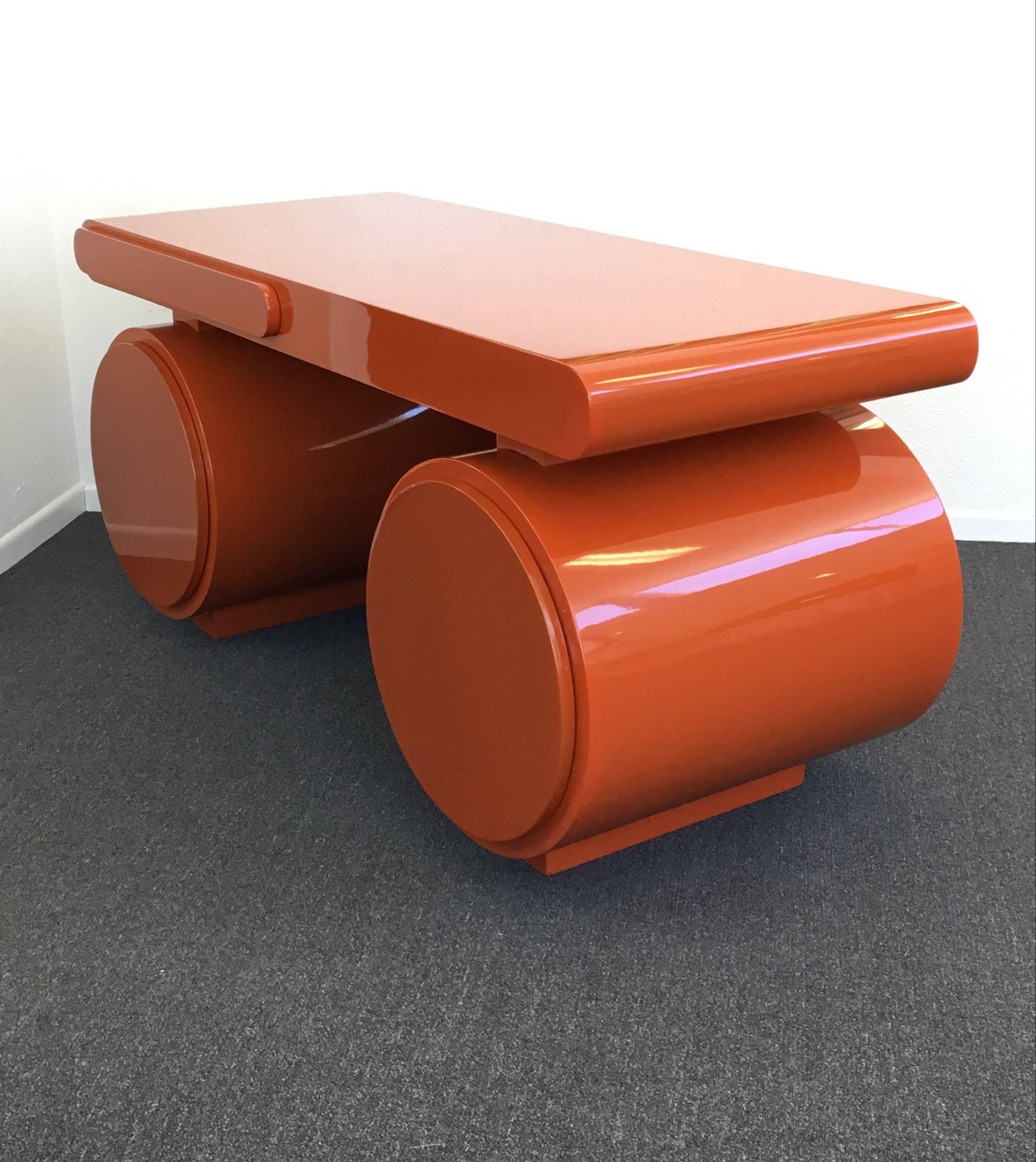 A spectacular 1960s scuptural desk with a orange high gloss lacquered finished. The desk has three drawers. One small of center top drawer and the two round bottom drawers are file size. 

DIM: 28.5