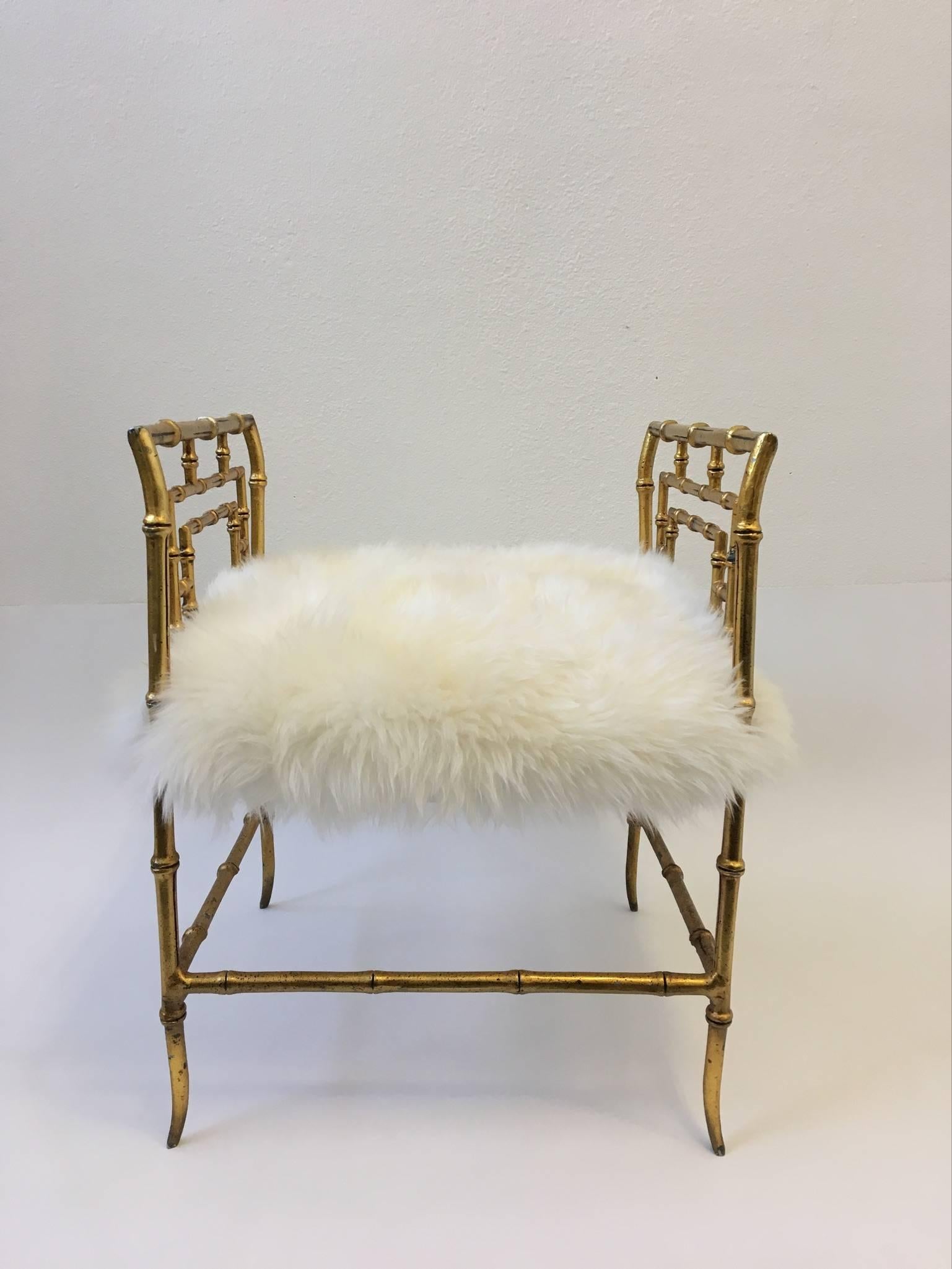 A glamorous 1970s gilded cast aluminium faux bamboo stool. The seat has been newly recovered with a nice off-white sheepskin.

Dimension: 24.5" high, 18" seat, 19" wide, 18" deep.
