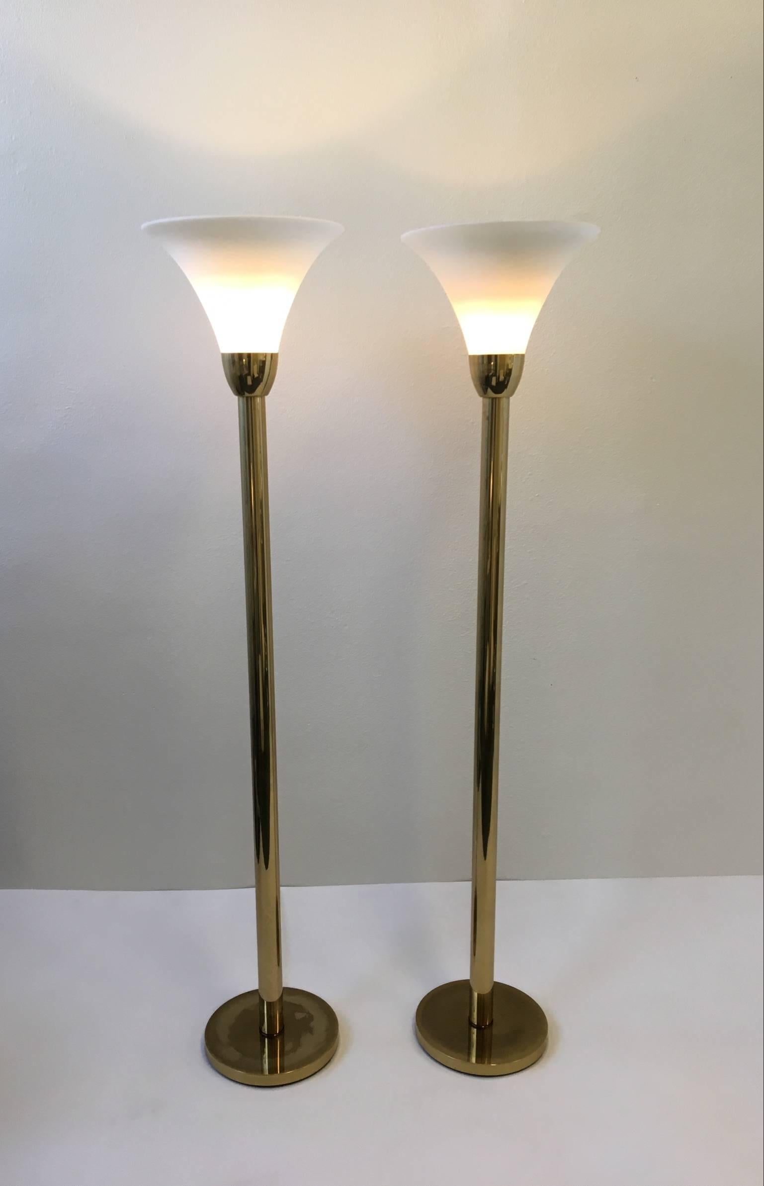 A glamorous pair aged brass and frosted glass shades torchiere floor lamps by Nessen Studios. The brass has a nice patina age to it. Please see detail photos.
The lamps have been newly rewired and have touch diameters.