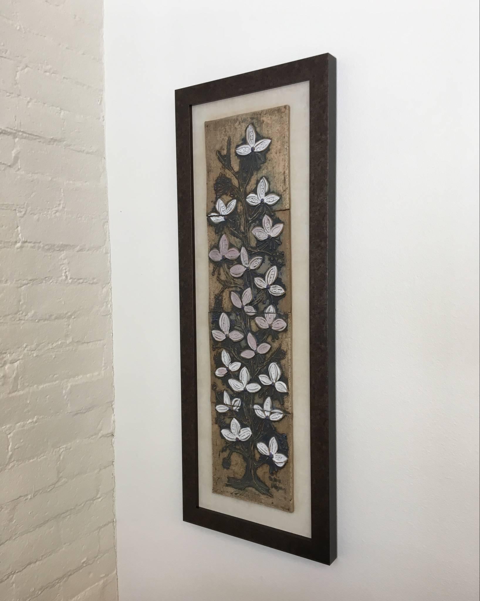 A large ceramic wall art of a beautiful flowering tree by California ceramicist Victoria Littlejohn. The flowers are glazed white and pink. This is signed on the longer right corner, see detail photos. Newly framed.
 

 