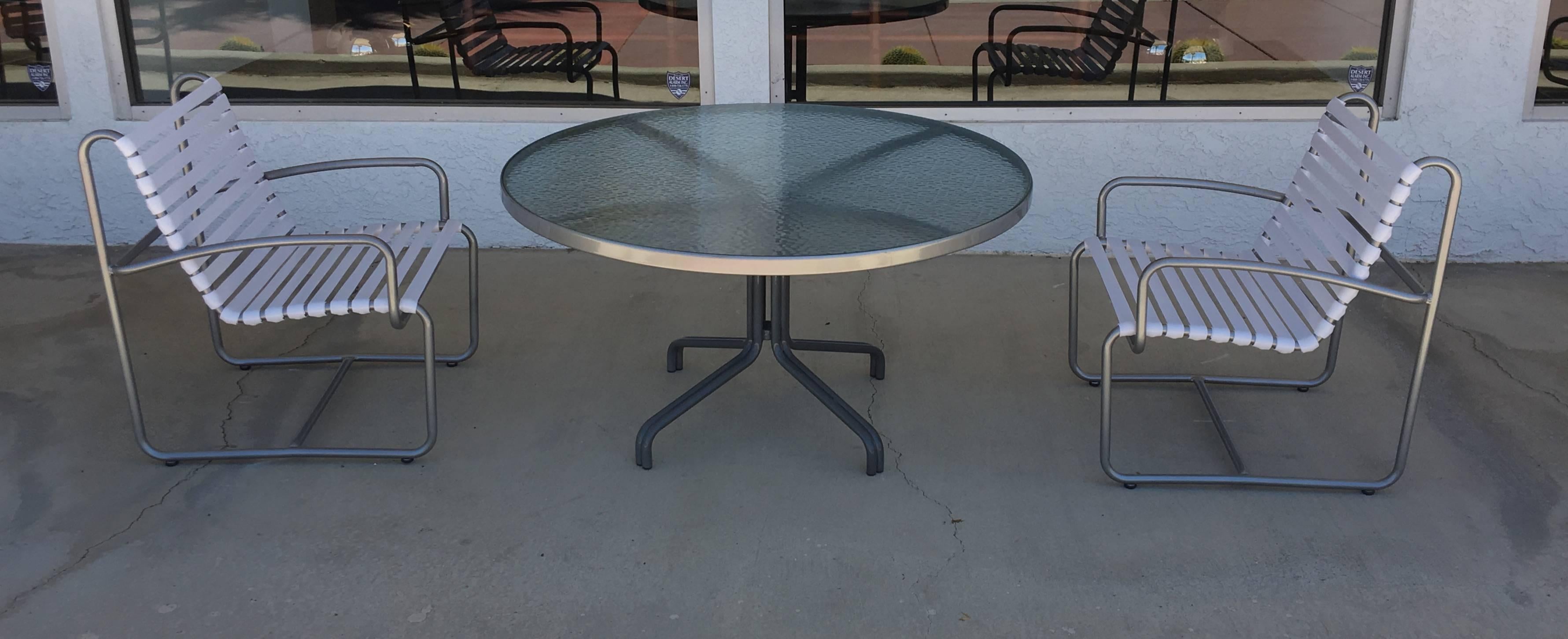 Outdoor five-piece dining set four chairs and dining table designed in the 1970s by Brown Jordan. The set has been newly professionally restored. The frames and table are powder-coated silver grey and white straps on chairs. 

Dimensions: 
Table