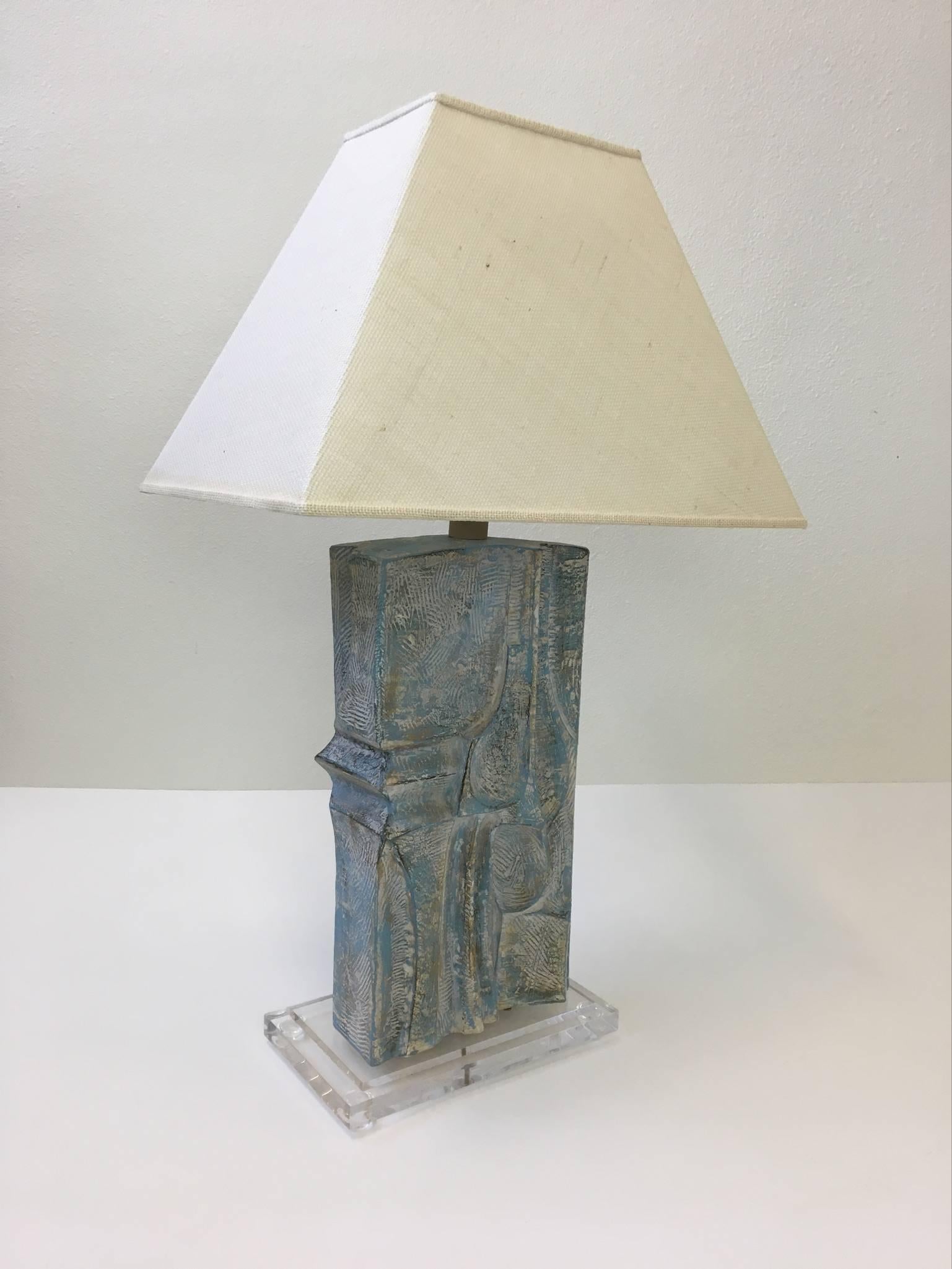 A sculptural Brutalist table lamp designed by Casual Lamps in 1987.
The lamp is cast plaster with had painted finish and acrylic base. 
Newly rewired with new nickel hardware and new off-white burlap shade. 

Dim: 22.25" wide, 15"