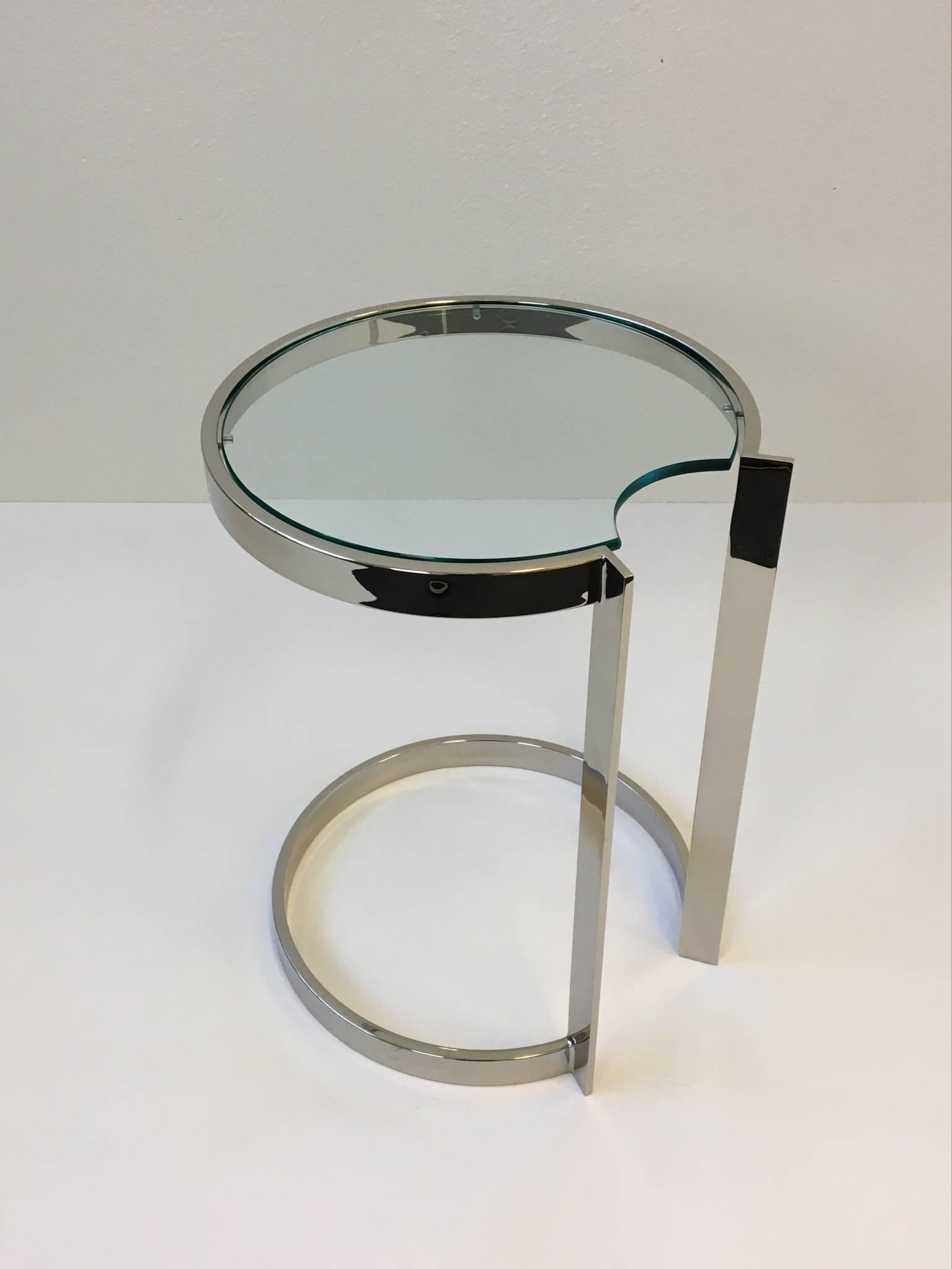 A 1970s occasional table in the style of Milo Baughman. Newly replated in a polished nickel finish. The glass is original, so it has minor wear.