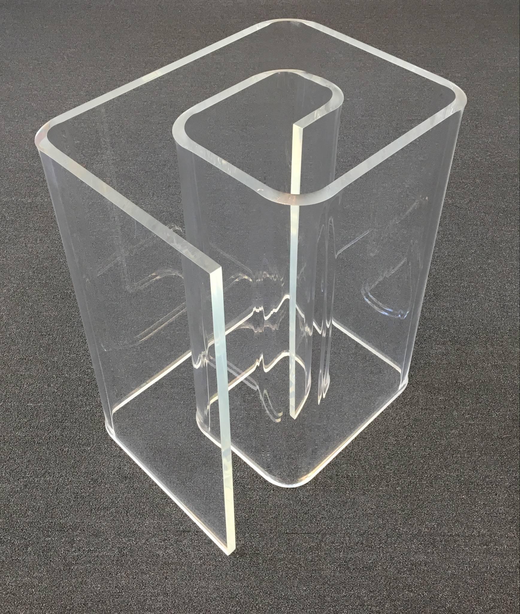 A 1970s acrylic and glass dining table in the shape of a snail.
The acrylic and glass top is 3/4