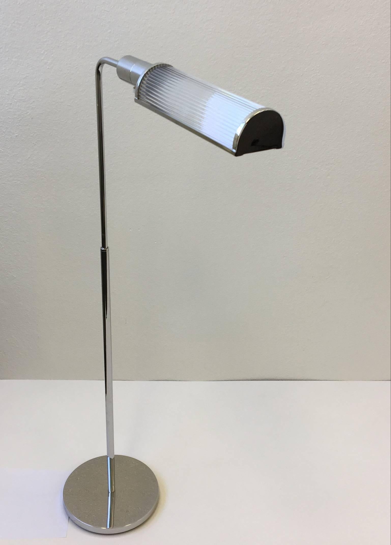 A pair of glamorous chrome and glass adjustable floor lamps designed by Casella in the 1970s. 
The lamps have been professionally restored.
The socket is a full range control dimmer.
You can rotate the lamp 360*.
The lamp is 48.5