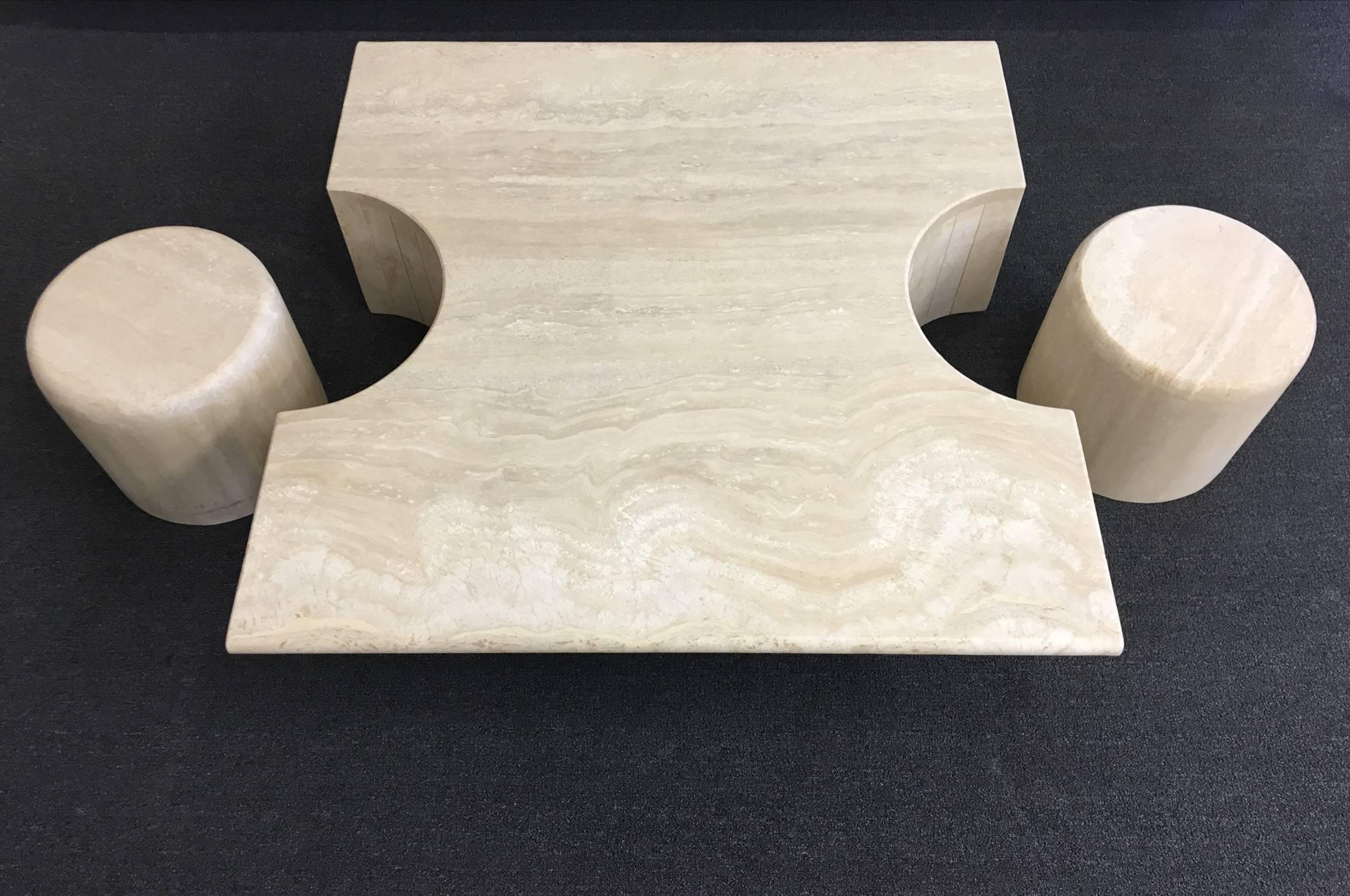 A spectacular three-piece Italian travertine cocktail table. The two drums can be used as side tables or ottoman. The finish is a satin finished. 

Dimensions: Pair of drums 13