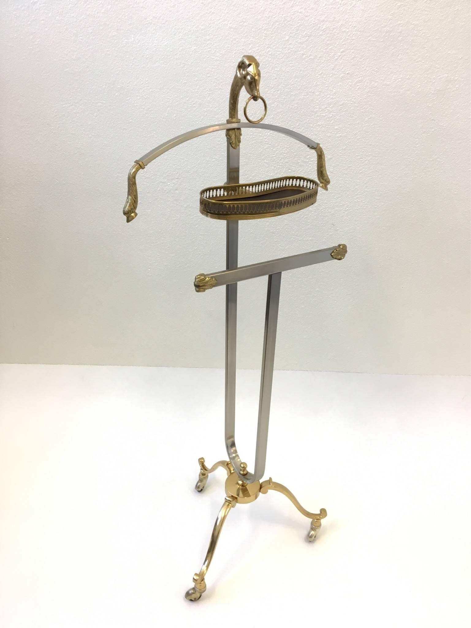 A glamorous masculant Italian valet designed in the 1970s.
Constructed of polished brass and brushed stainless steel. 
Dimensions: 46