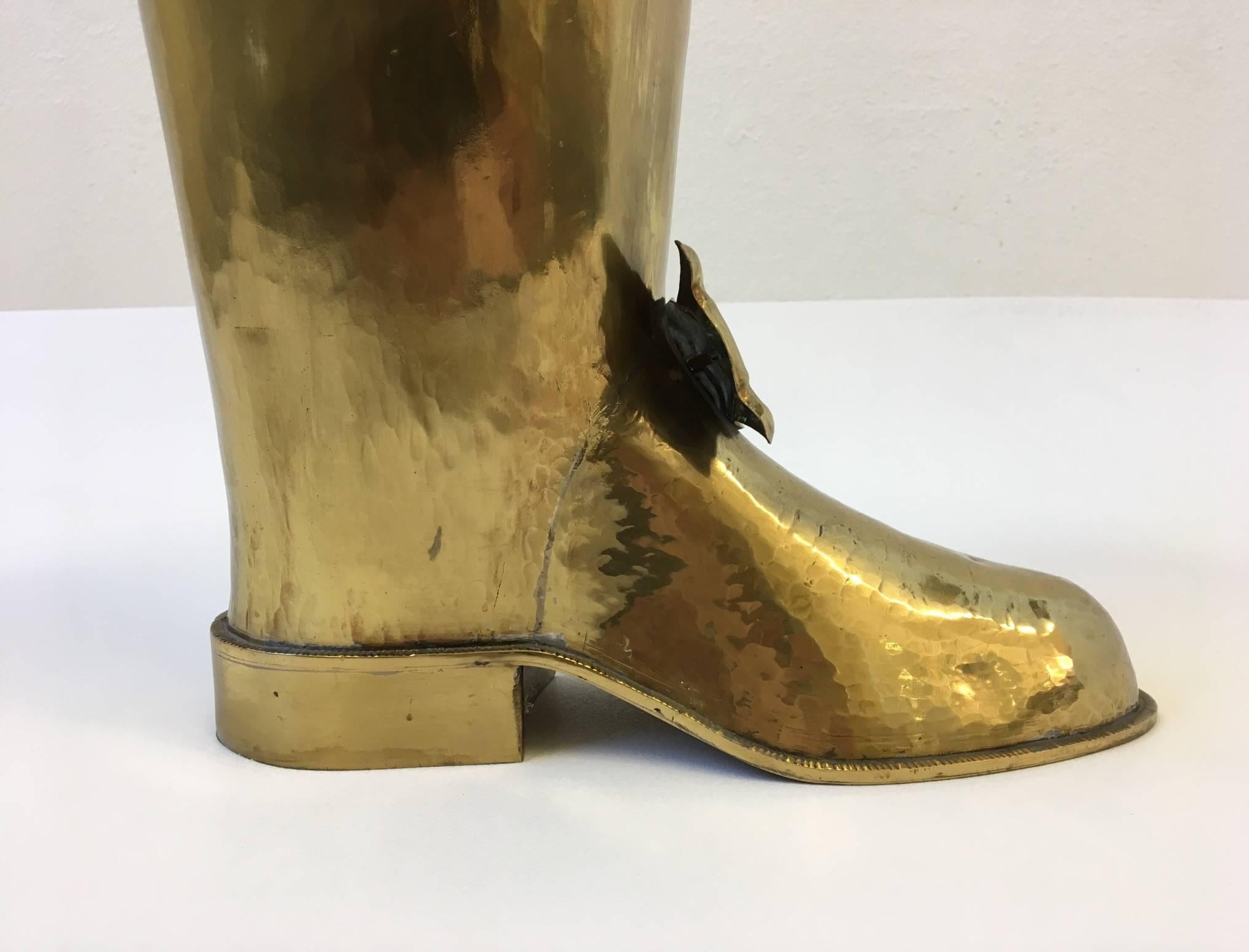 A fun 1970s hand-hammered solid brass boot umbrella holder.
Marked made in Spain on the heel. 
Dimensions: 21.75” high 12” wide 7.5” deep.