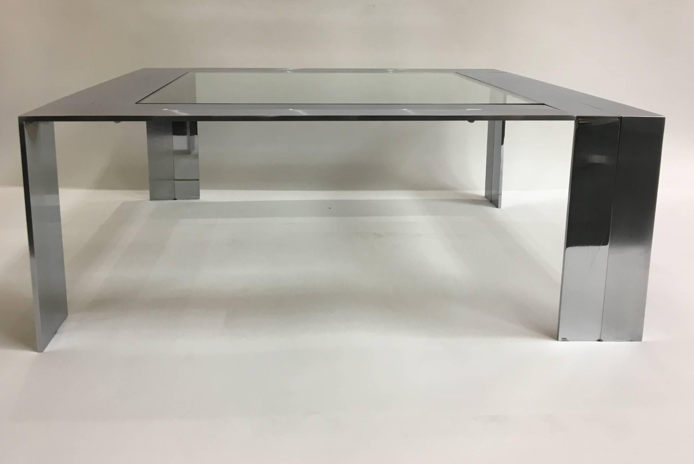 An abstract sculptural solid stainless steel cocktail table designed by artists Elain in the 1980s for Design Institute of America. The table is constructed with solid polished and brushed stainless steel welded together, to form a great graphic