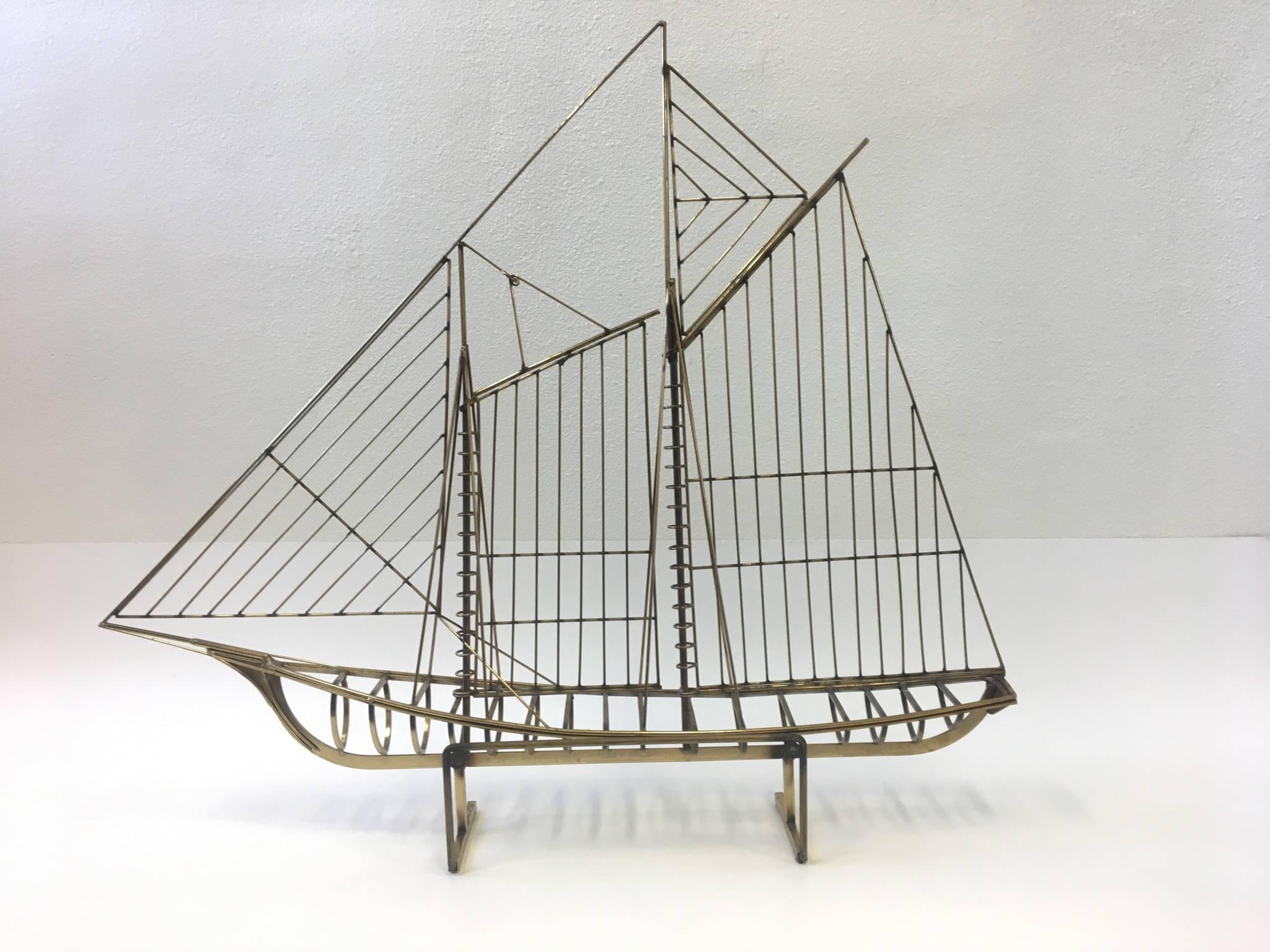 A 1976 large brass ship sculpture by Curtis Jeré. The sculpture is in original condition. So it shows some age, it's signed and dated. The sculpture can be mounted on the wall if desired. 
Dimensions: 47 inches wide, 7 inches deep, 41 inches high.