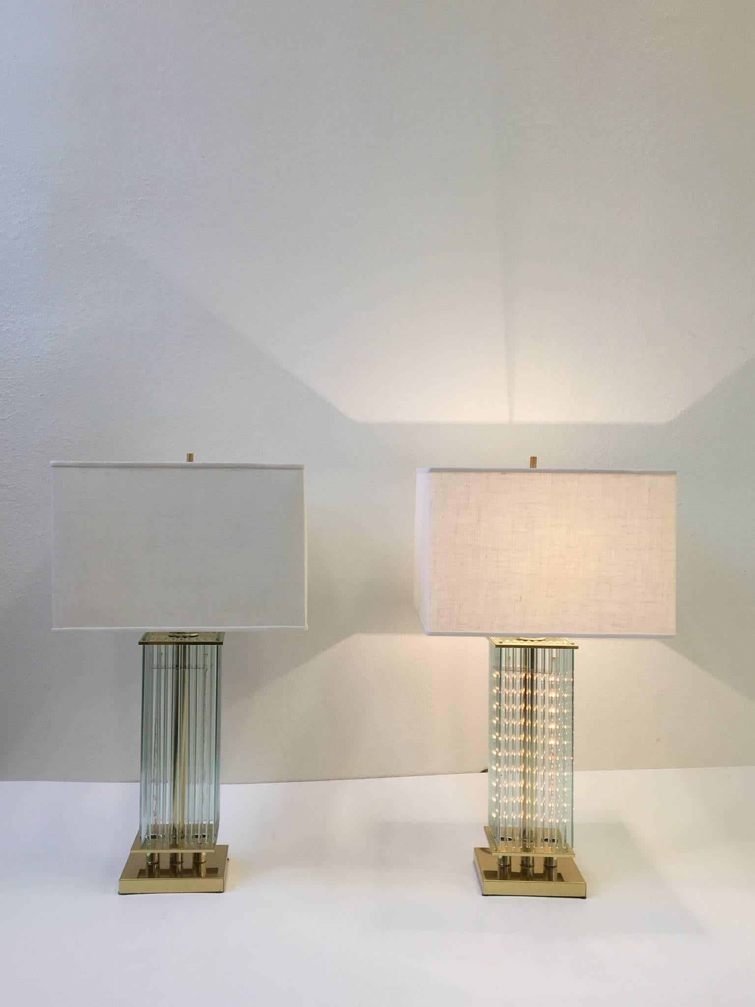 A glamorous pair of polished brass and glass rods with new vanilla linen shades. Designed in the 1970s by Gaetano Sciolari for Lightolier. Newly rewired.
The lamp takes two lighting rods that lights through the glass rods and one regular Edison