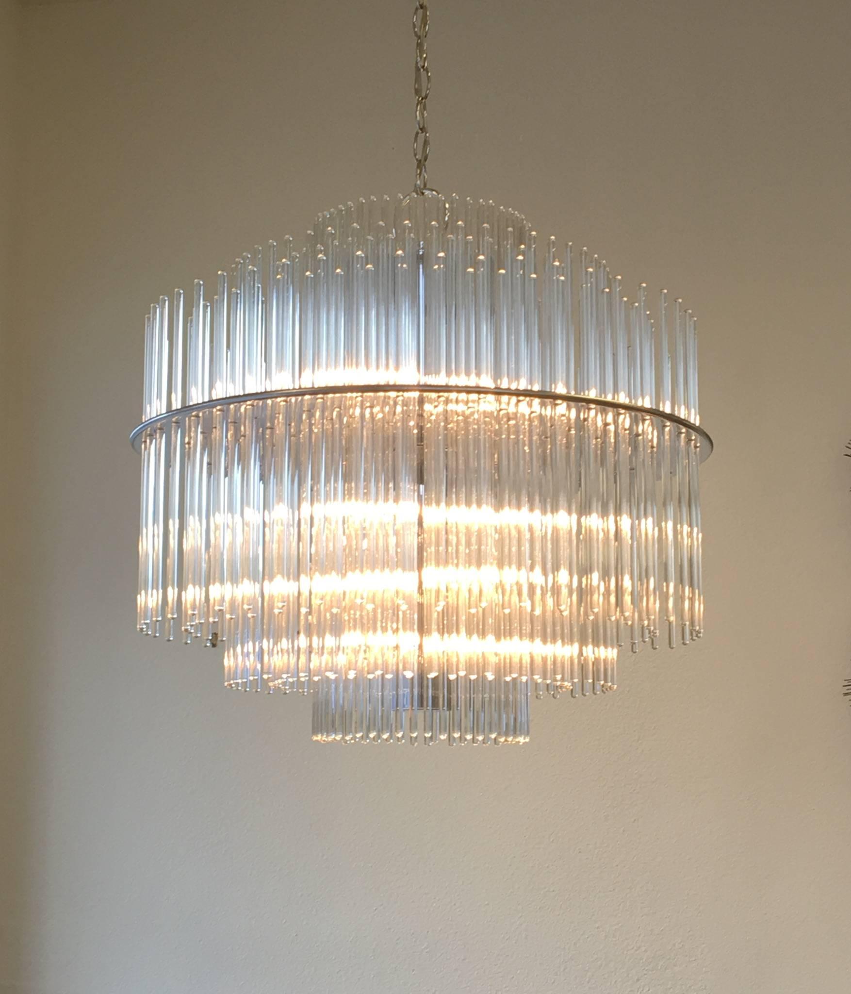 A glamorous polished chrome and glass rods chandelier designed by Lightolier in the 1970s. Newly rewired. We can make the chain any length you want.
Dimension: 22.5 inches diameter x 21.5 inches high.