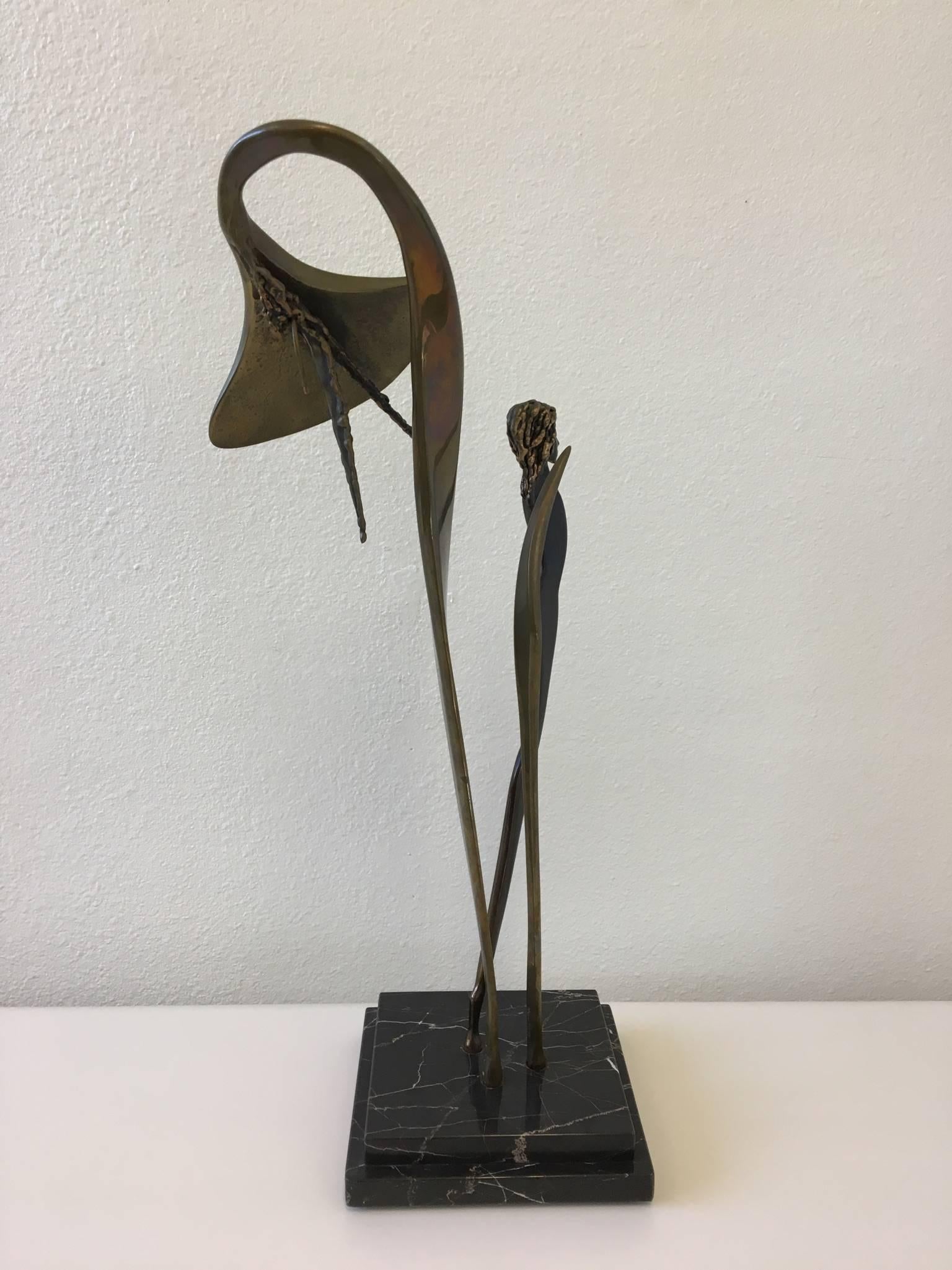 A beautiful cast bronze and black marble sculpture of flower with woman by McLean from 1986.
The sculpture is signed McLean and dated 1986. 
Dim: 25.5 inches high, 10 inches wide and 8 inches deep.
