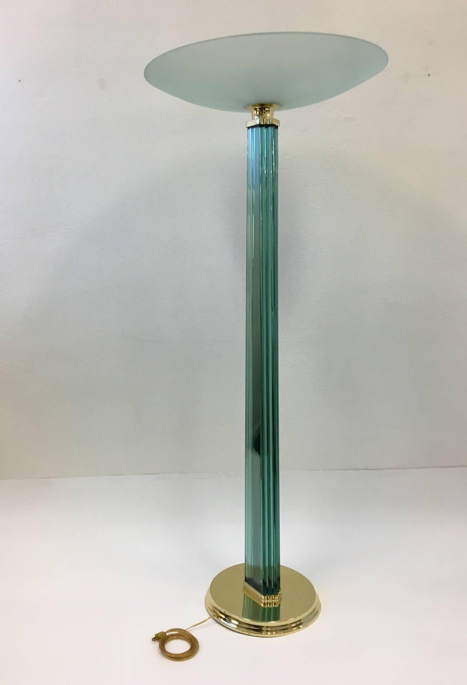 A spectacular Italian glass and polished brass Torchiere made in the 1950s in the style of Fontana Arte. The lamp has been newly rewired and re-plated. The lamp takes six candelabra lightbulb.
Dimensions: 68.5 inches high and 28 inches diameter.
