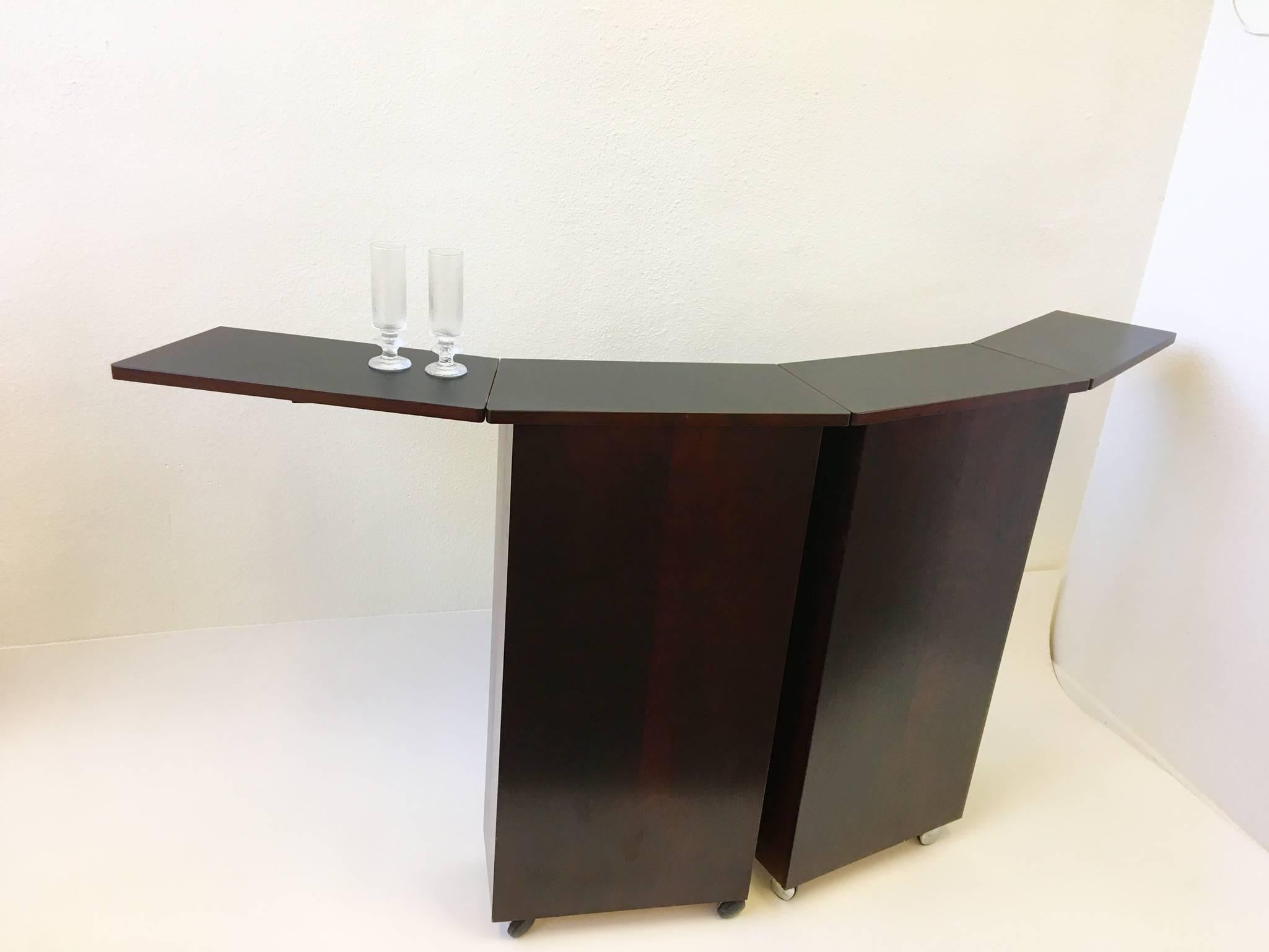 An amazing 1970s Danish rosewood folding portable bar by Danish designer Niels Erik Glasdam Jensen for Vantinge Møbelindustri. The bar is very elegant when opened and when closed up since it's all rosewood. The top is black formica when opened
