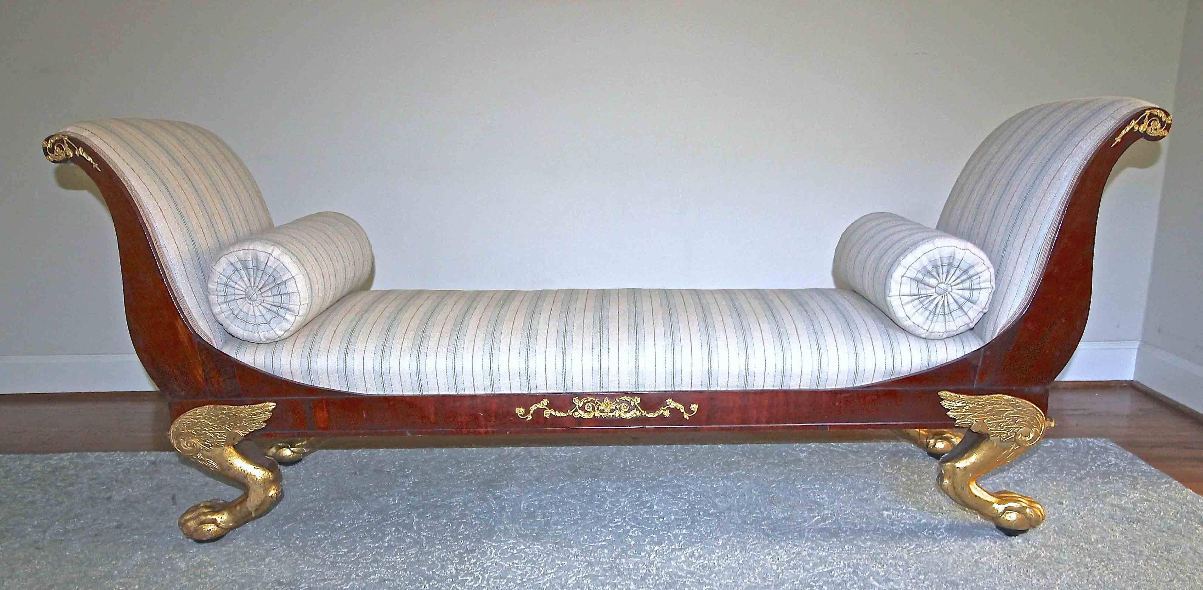 A very fine Swedish early 19th century Empire mahogany recamier or day bed with carved water gilt gold winged paw feet. Decorated with gilt bronze ormolu mounts. The narrower width accommodates use as bench at foot of bed or as a window seat.