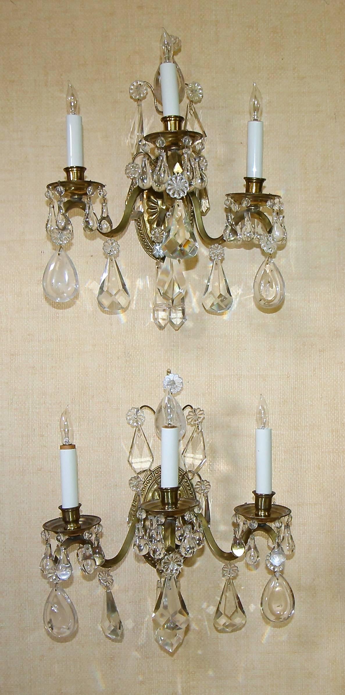 Pair of 1920s French three-arm light brass wall sconces with combination finely cut crystal and rock crystal prisms.