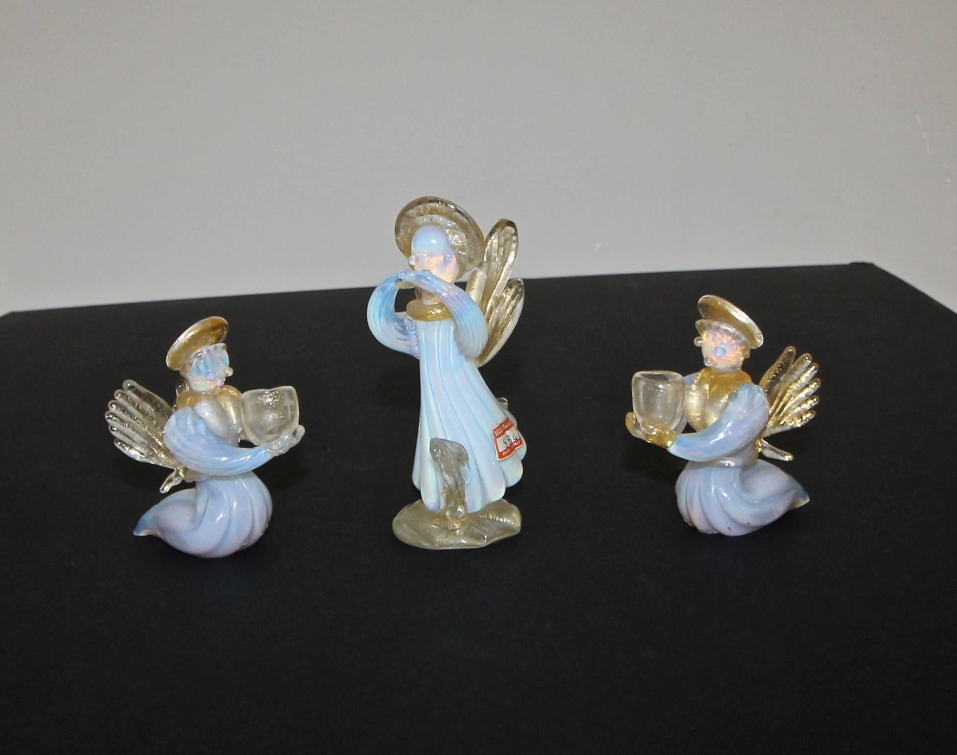 Set of three diminutive opalescence and gold handblown Seguso Murano candleholder Angels.
Two smaller angels hold candles the larger angel does not.
Measure: The tallest Angle is 5" the other two 3.5" tall.